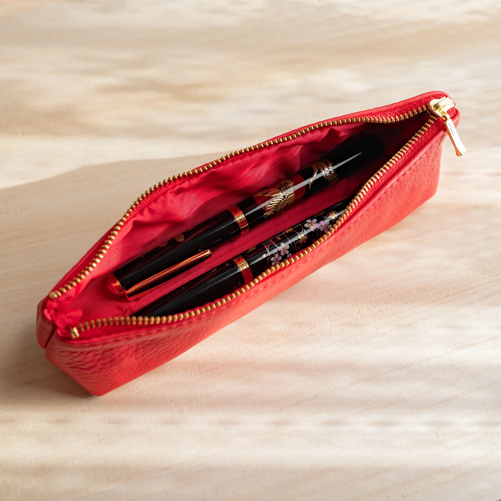 Red leather pen case showing vibrant color and steerhide quality and features and features and features