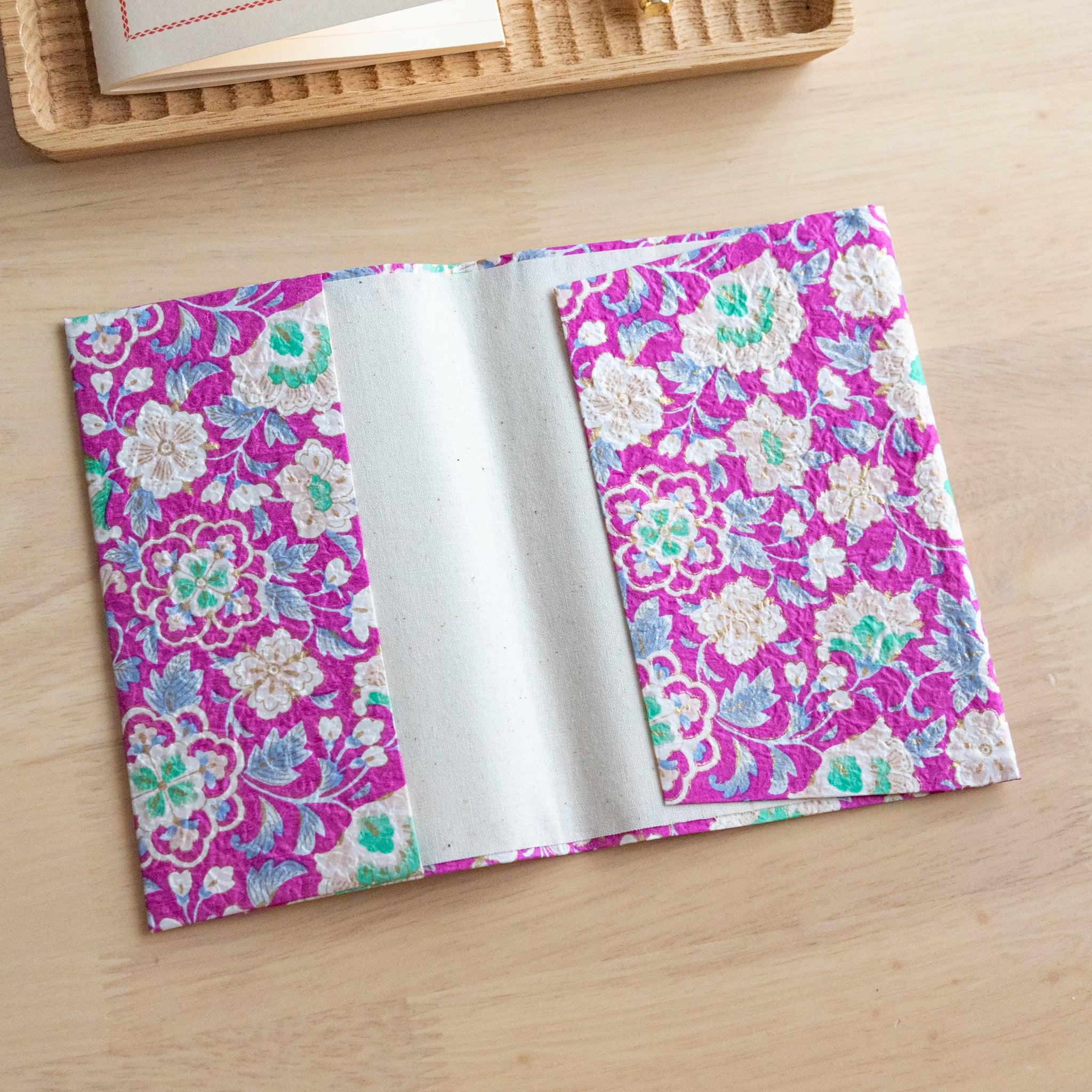 Magenta garden hand-dyed yuzen washi book cover A6, vibrant pink yuzen design with ornate floral embroidery visible