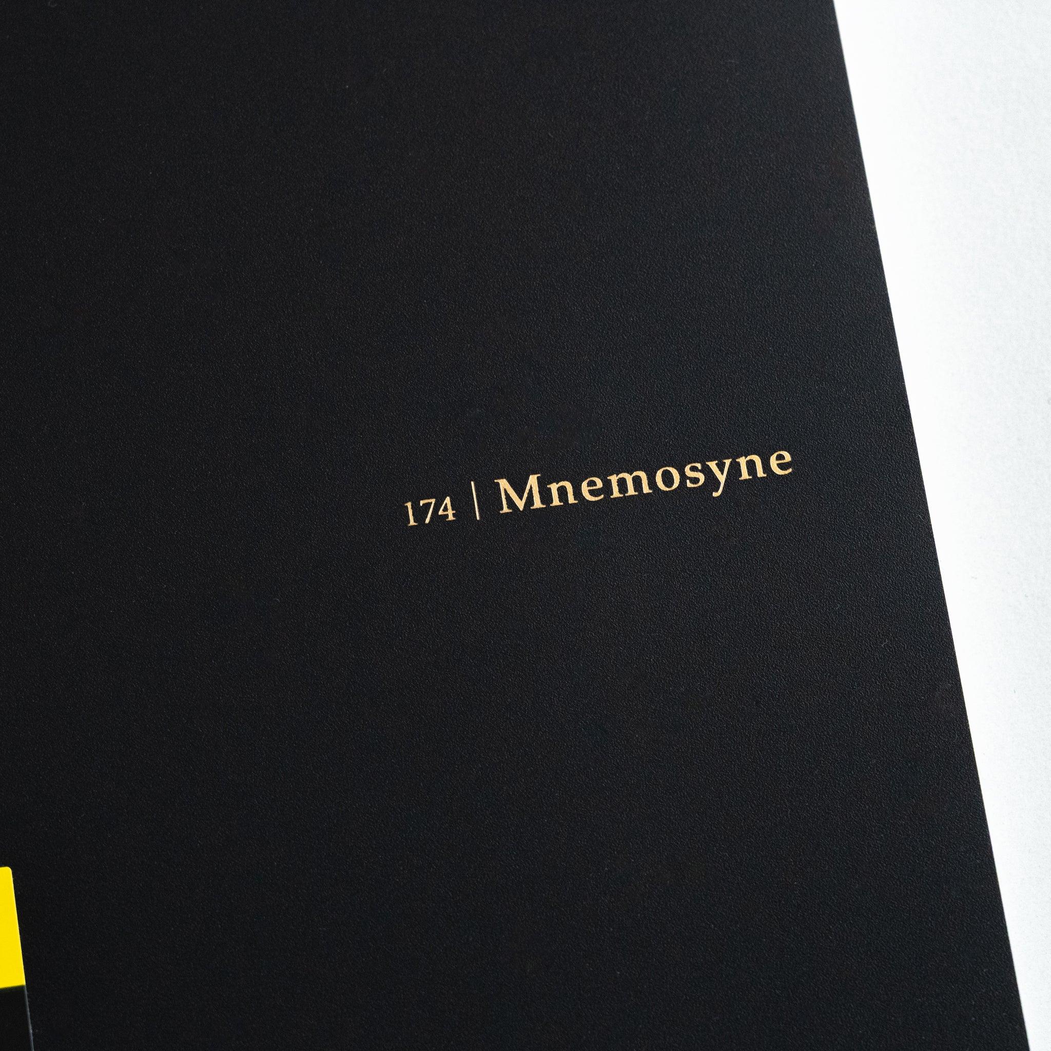 Maruman Mnemosyne notebook, flat lay showing closed white cover, Mnemosyne Japanese notepad with detachable sheets and