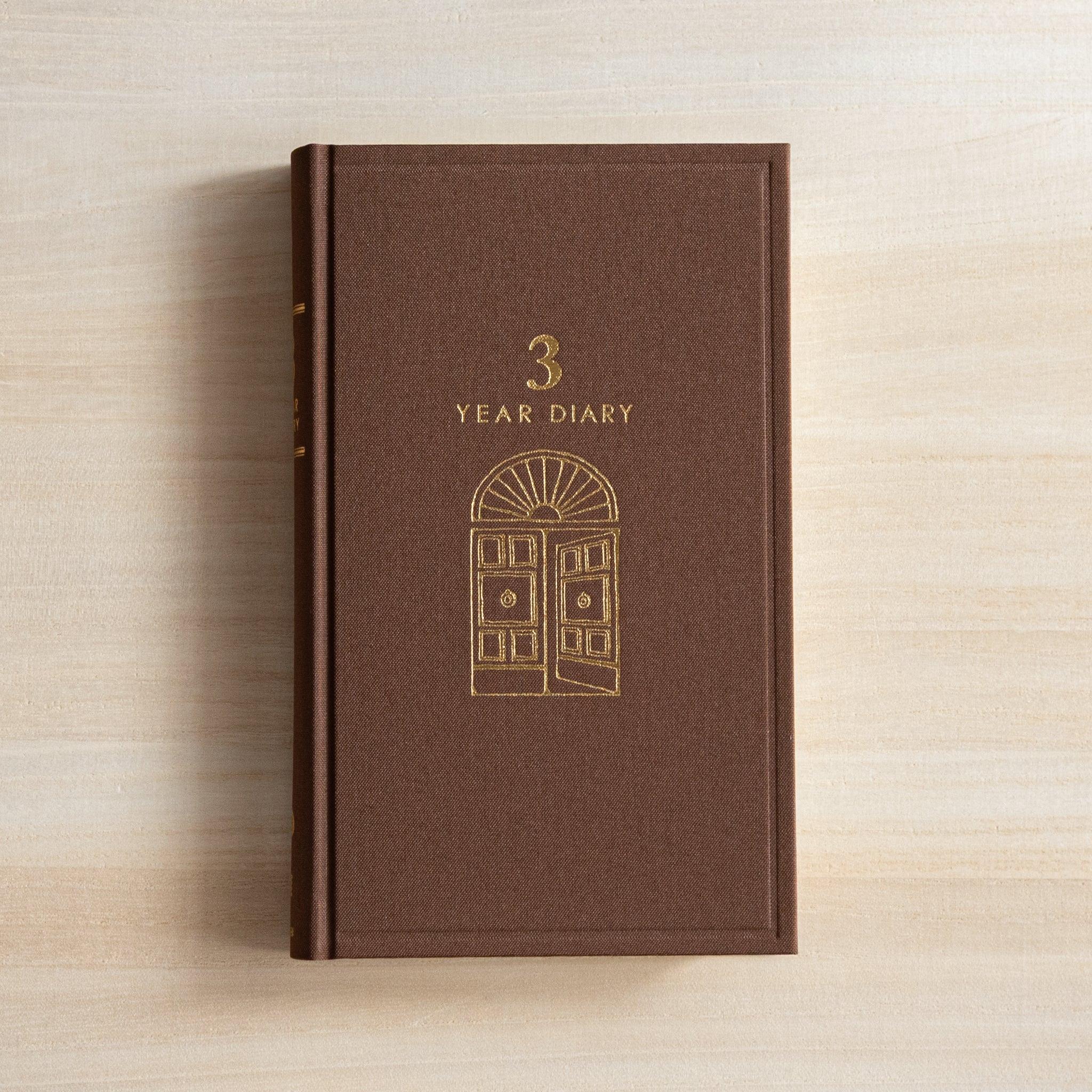 Midori 3-year journal, flat lay showing closed cover with gate pattern, Midori 3-year journal with embossed cover for