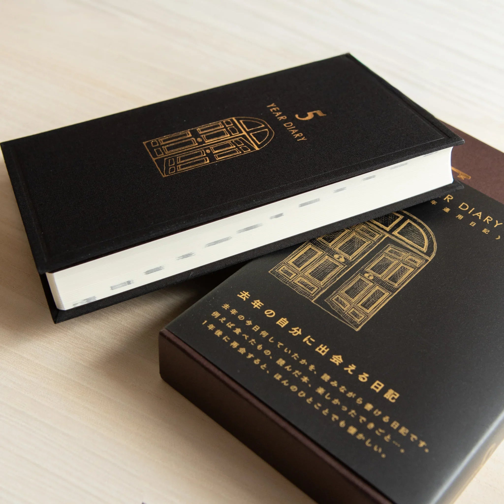 Midori 5-year journal, flat lay showing closed cover with visible gate pattern, Japanese stationery with quality materials