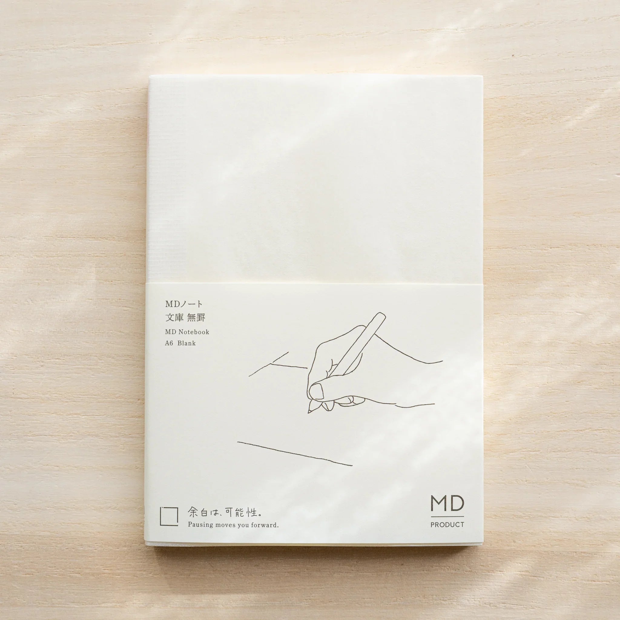 Midori MD Notebook A6 Blank with glassine cover, black hand-writing illustration and MD Product logo on front