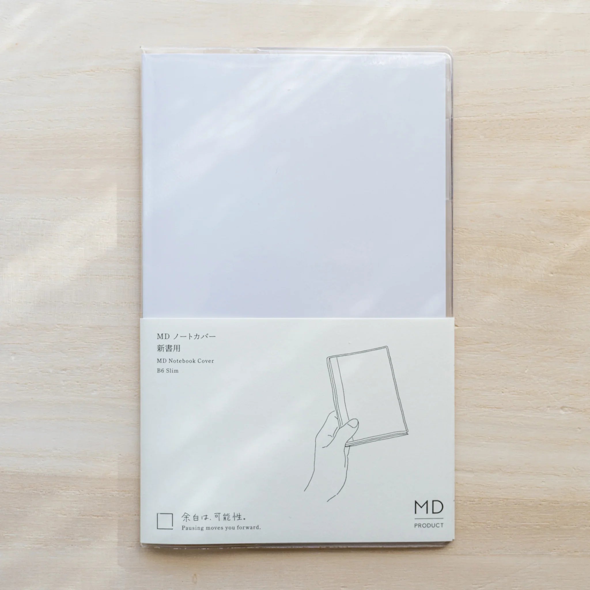 Midori MD Notebook Cover B6 Slim in packaging, clear PVC cover with paper band and size label