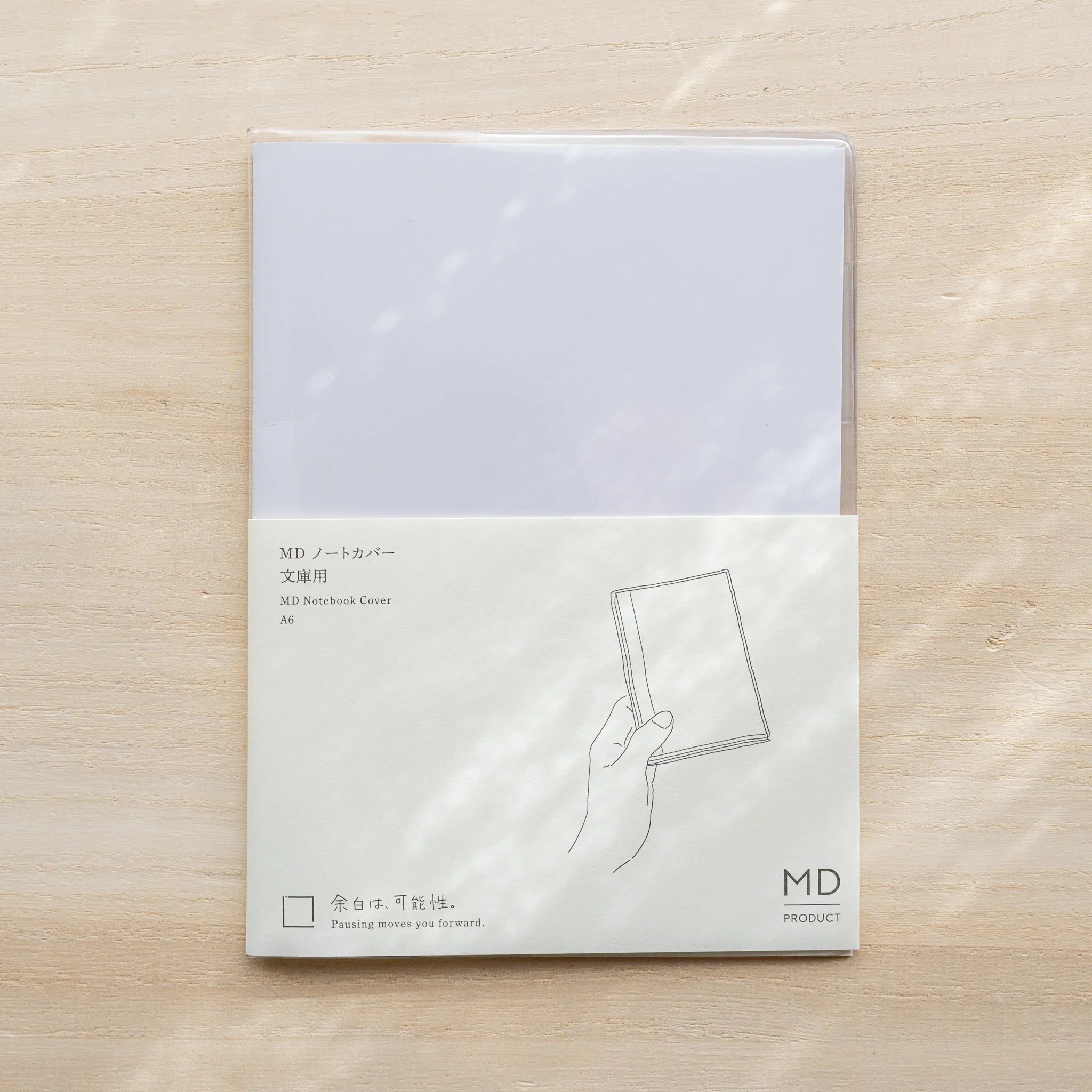 Midori MD Notebook Cover A6 in packaging, clear PVC cover with paper band and size label