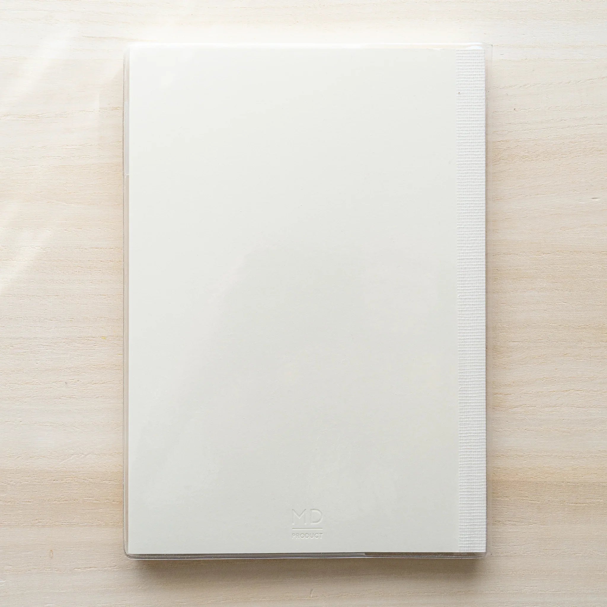 Front of a white MD notebook with MD PRODUCT logo at lower right inside a clear PVC cover
