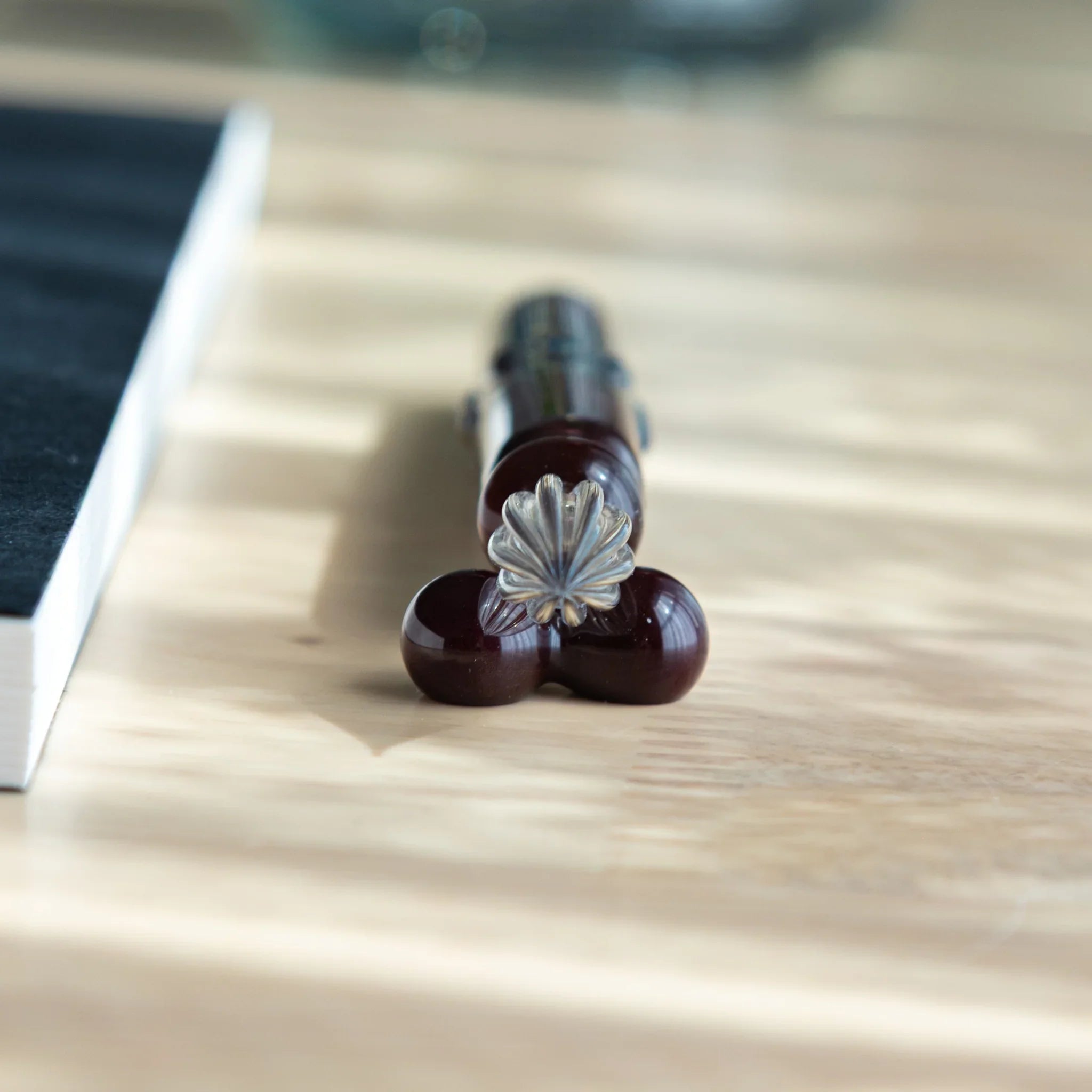 Mirror sphere glass dip pen at angle showing brush nib and shiny reflective glass sphere accent detail