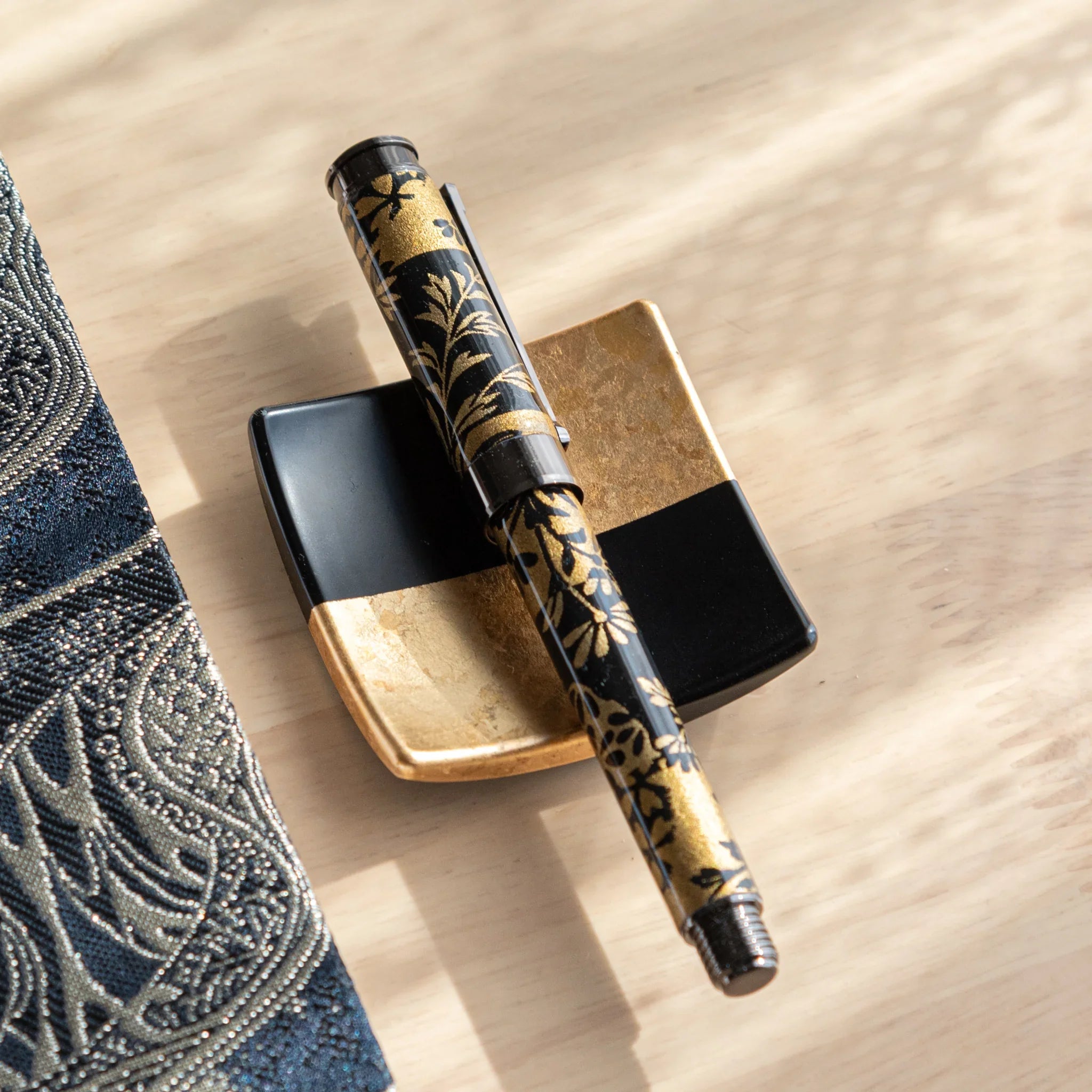 TACCIA fountain pen with black and gold Mino washi featuring autumn grass botanical pattern, front angled display view