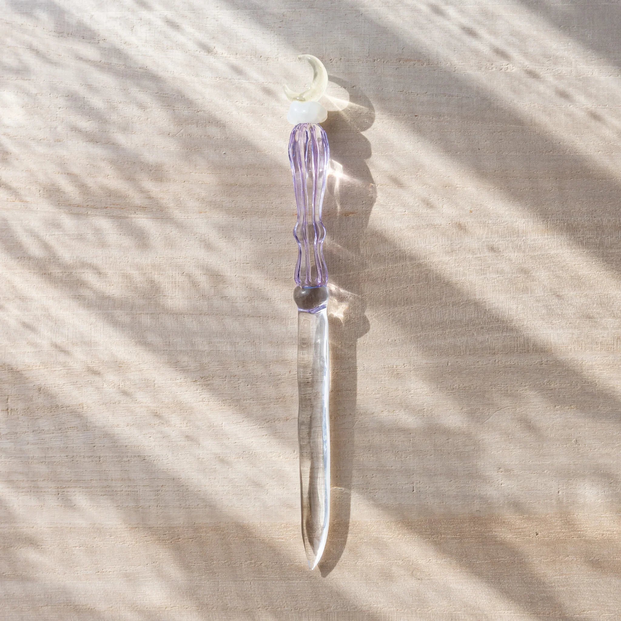 Moonlit cloud glass letter opener with lavender tint shown in composition shown in composition product composition view