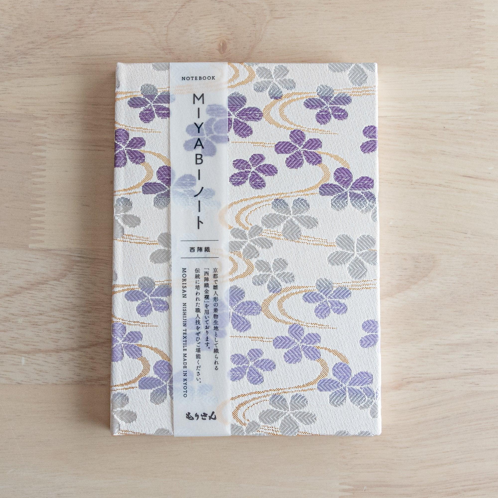Japanese Nishijin textile B6, angled shot of Streamside Sakura pattern brocade design detail with binding