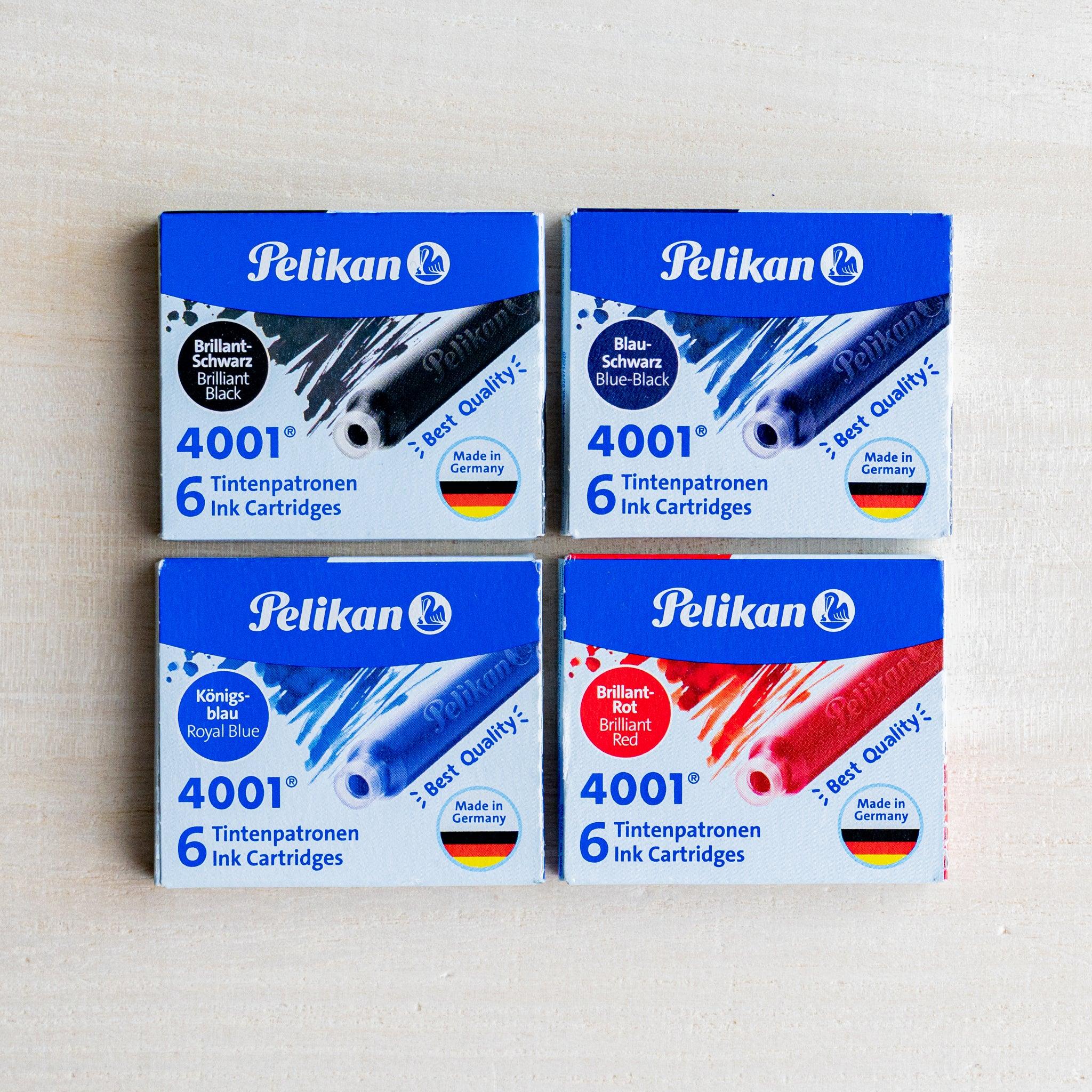 Four Pelikan 4001 ink cartridge boxes in black, blue-black, royal blue and red, blue and white packs, Made in Germany