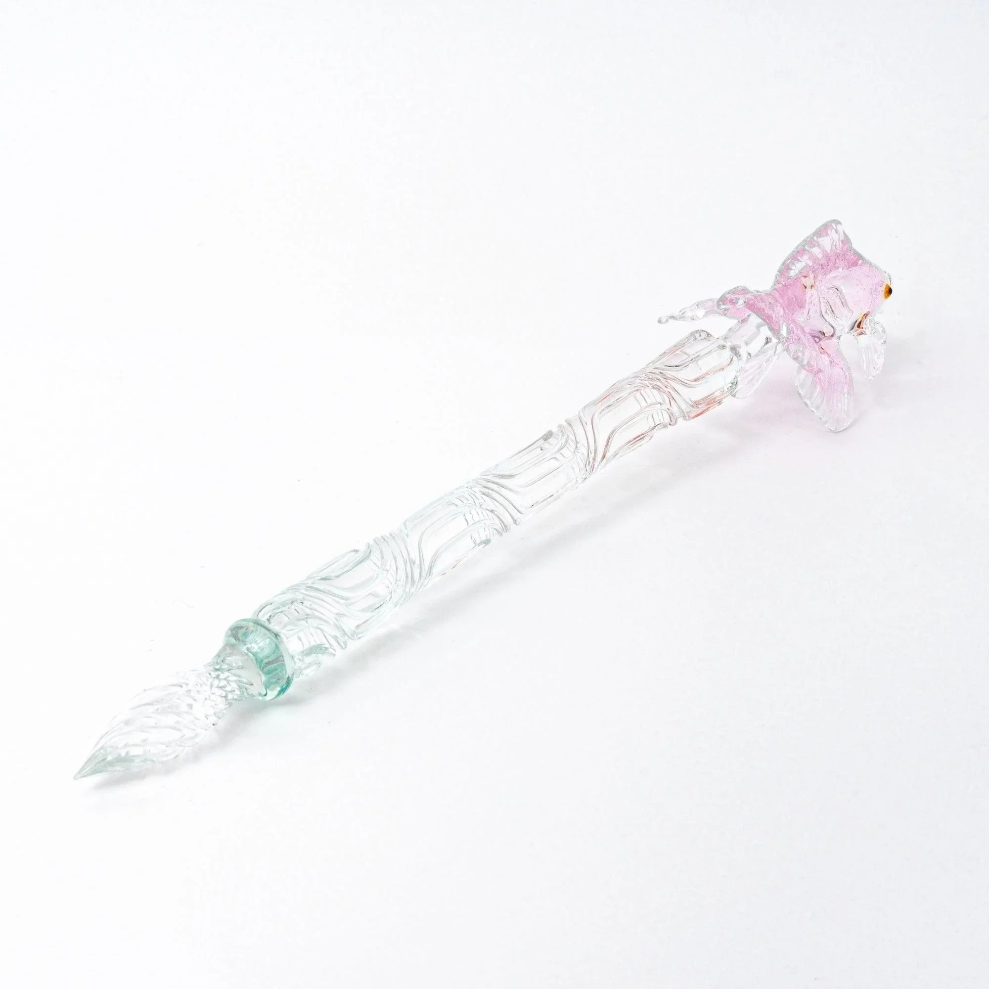 Japanese pink glass dip pen for lettering displayed with goldfish design and decorative metal components with holder