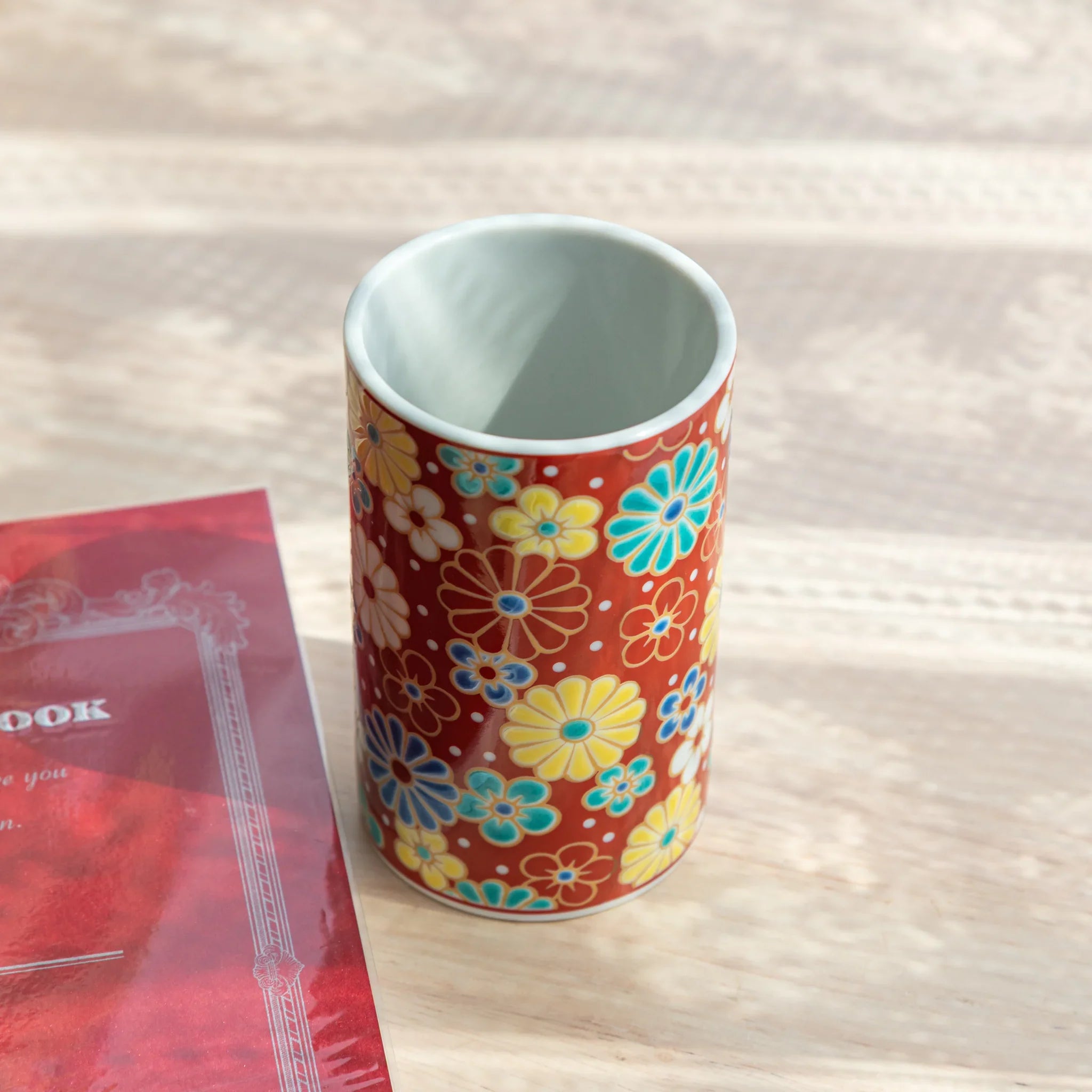 Decorative Kutani ceramic pen holder with plum and chrysanthemum pattern for desk storage featuring traditional porcelain