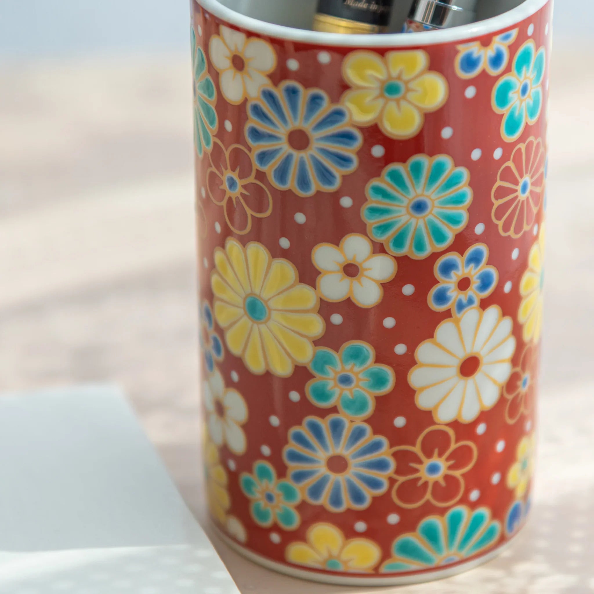 hand-made Kutani ceramic pen holder with hand-painted plum and chrysanthemum motif for refined desk organization