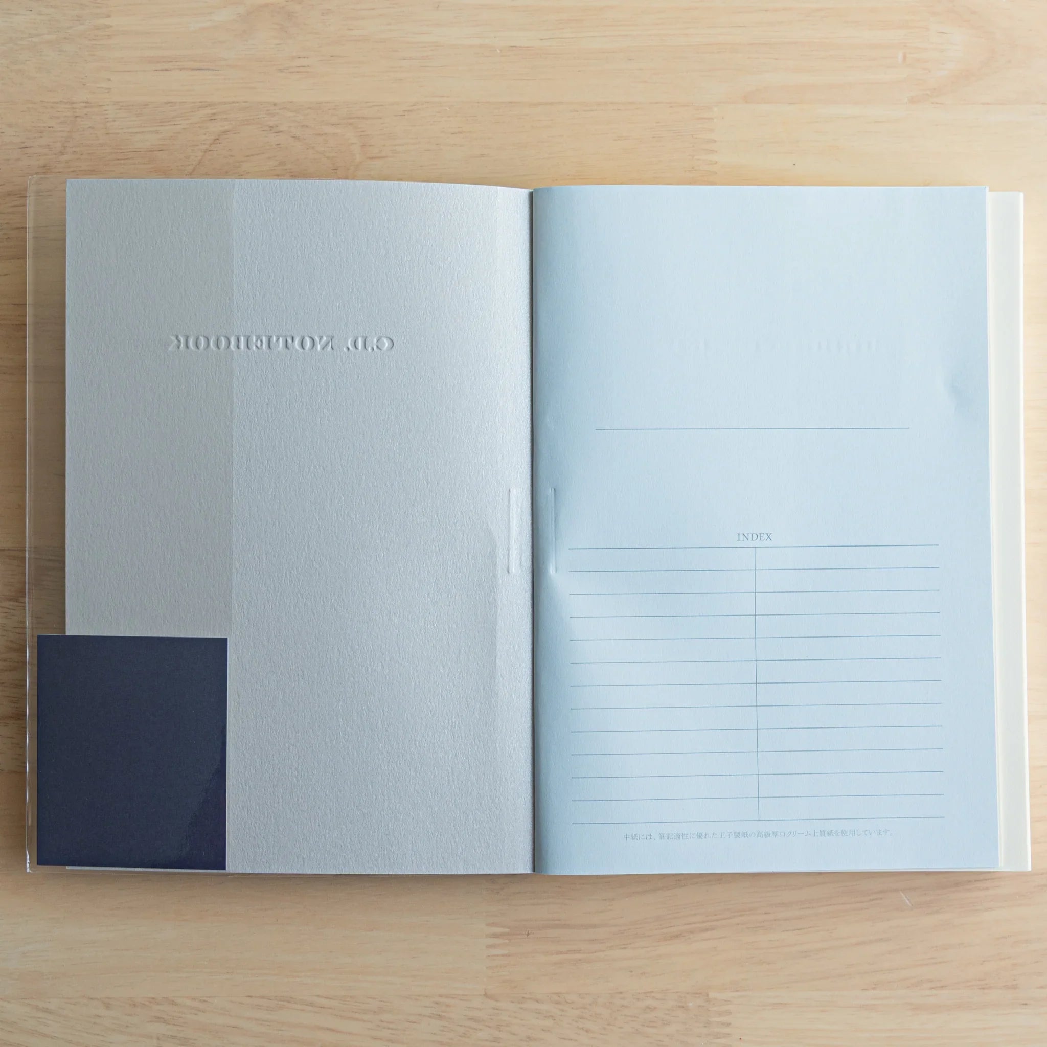 Apica Premium CD A5 fountain pen notebook open spread showing lined index pages on light blue paper, Japanese stationery