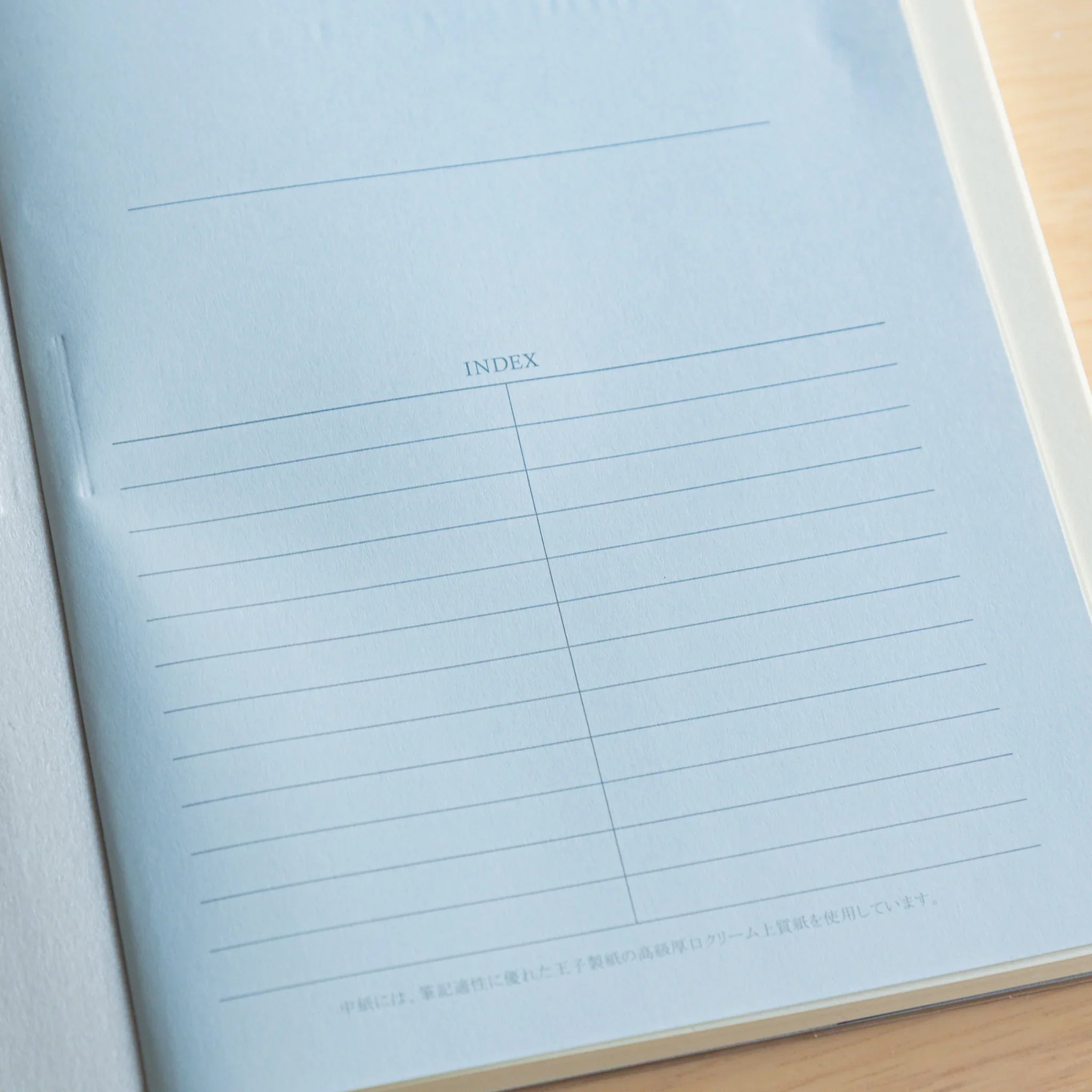 Apica Premium CD A5 cream-colored notebook interior pages displaying fine ruled lines and index columns, made in Japan