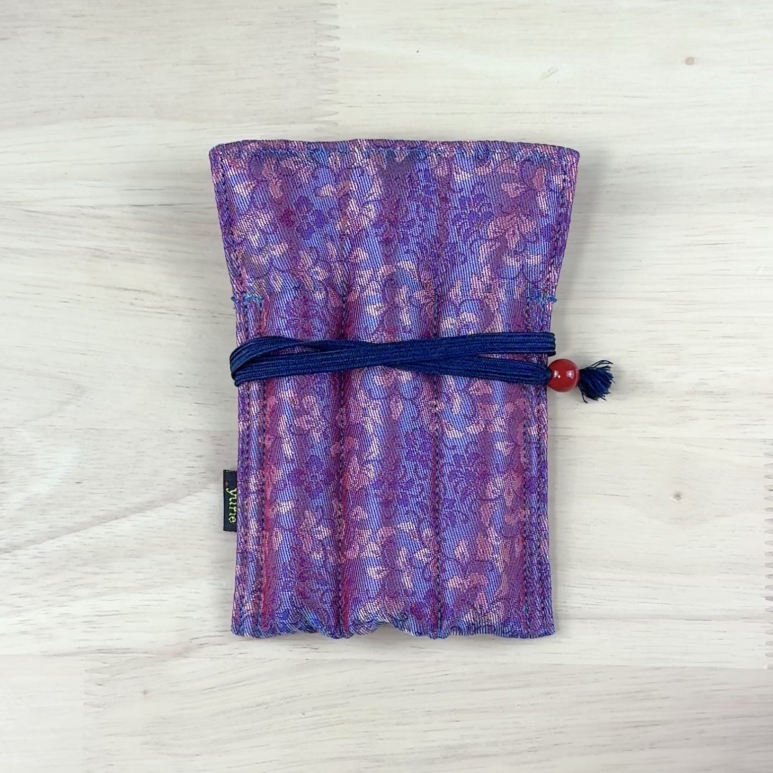 Nishijin textile B6 notebook with geometric pattern woven in gold, front view showing Japanese brocade weaving