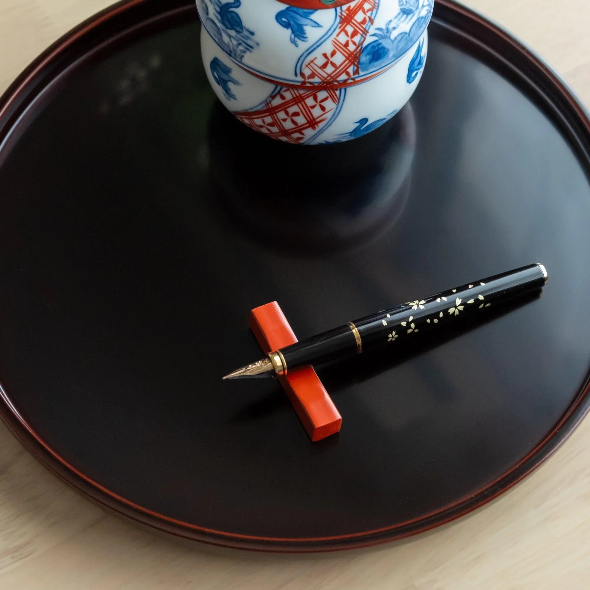 Japanese Echizen red lacquer pen rest made from sakura wood with smooth finish, keeping pens secure during work