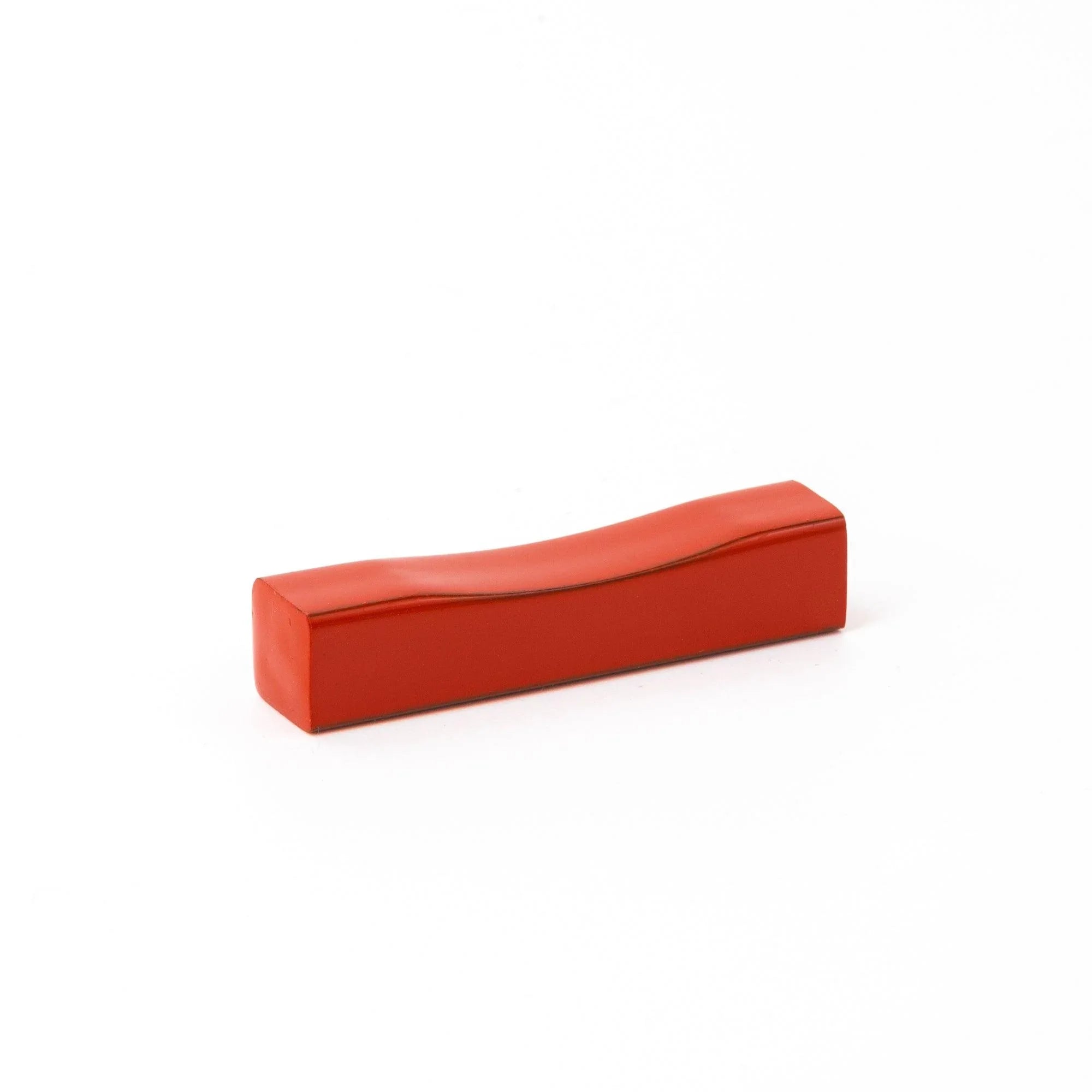 Traditional Echizen lacquer pen rest features vibrant red glaze with sakura wood base, keeping pens secure during work