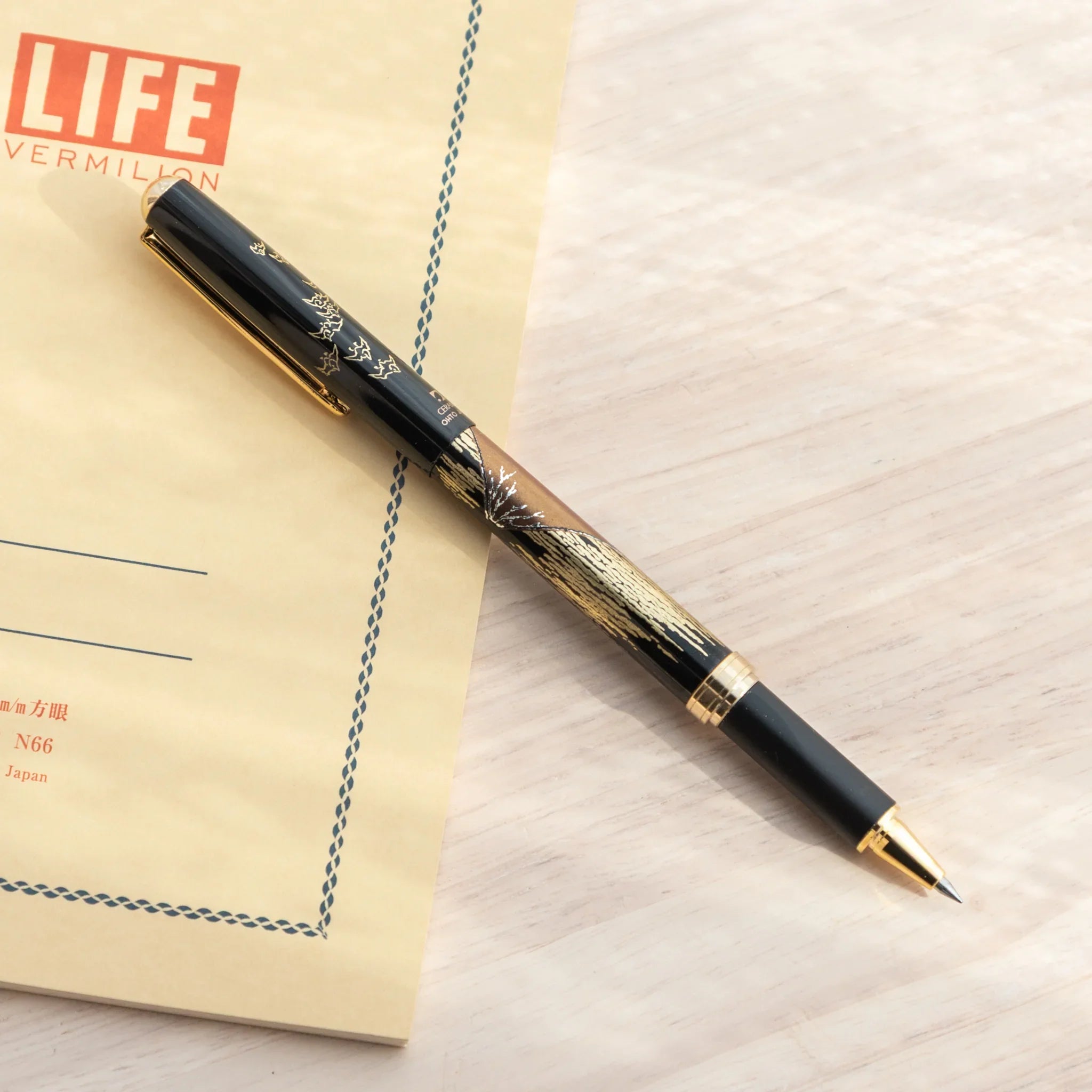 Traditional Japanese Yamanaka ballpoint pen features red fuji and scenic landscape artwork design for writing