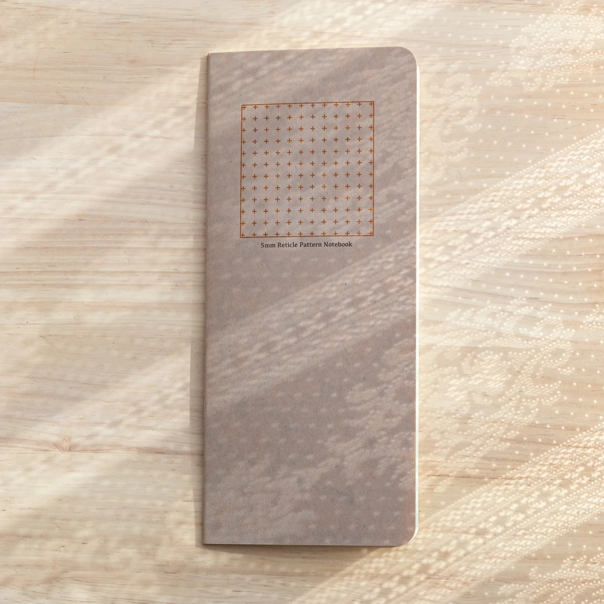 RO-BIKI Basic 5mm reticle grid notebook displayed flat showing cover and interior ruling pattern, Japanese stationery