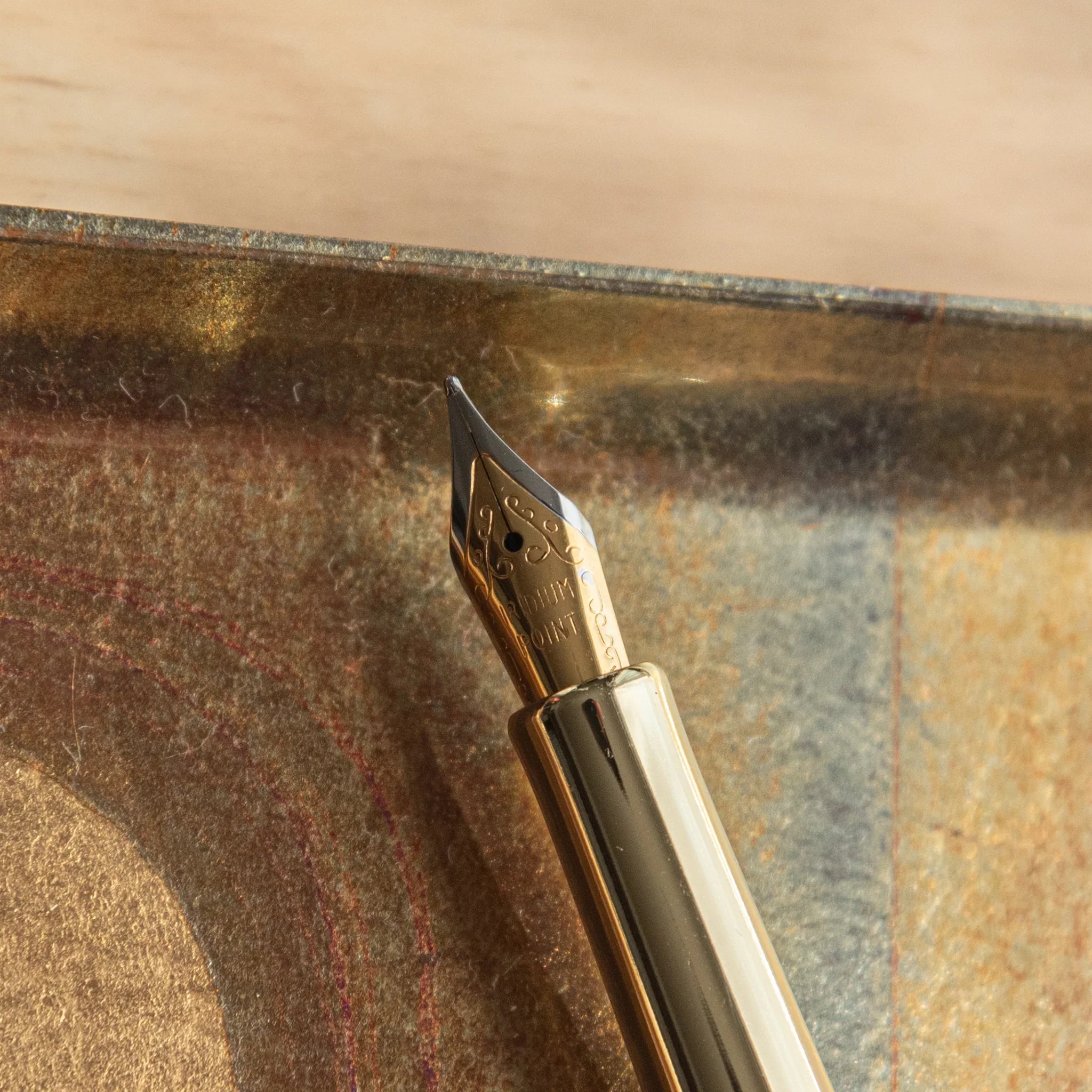 Sakura and Canola Mino Washi fountain pen cap showing metallic gold components on botanical patterned wrapper nib