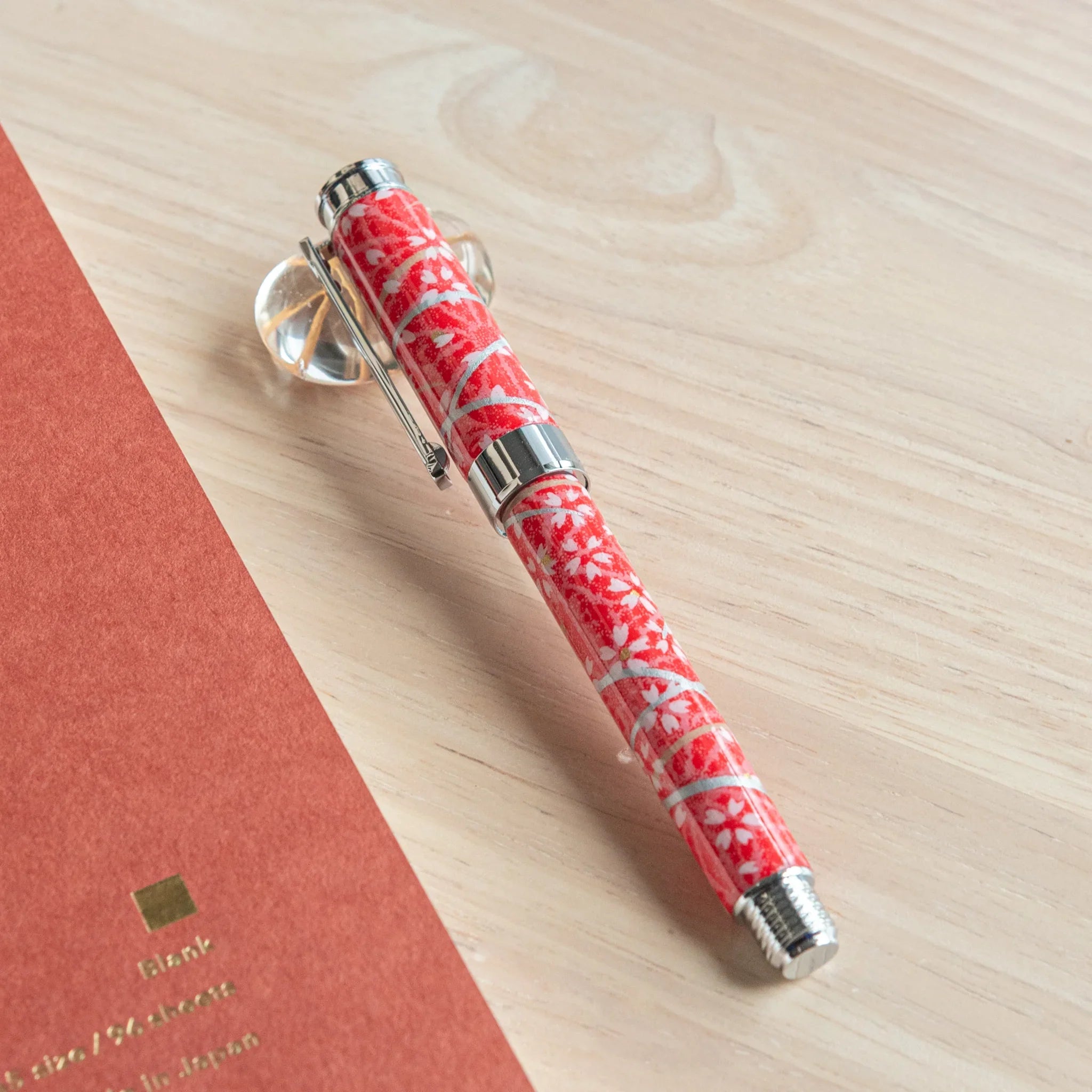 Red Mino washi fountain pen with white hemp leaves and cherry blossom pattern featuring Japanese aesthetic angle