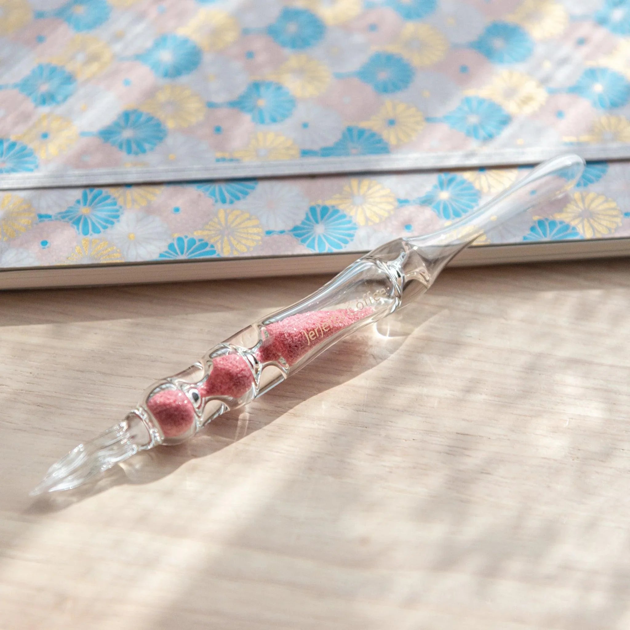 Sakura Hourglass Glass Dip Pen detail showing hourglass-shaped glass barrel with pink sakura cherry blossom pattern