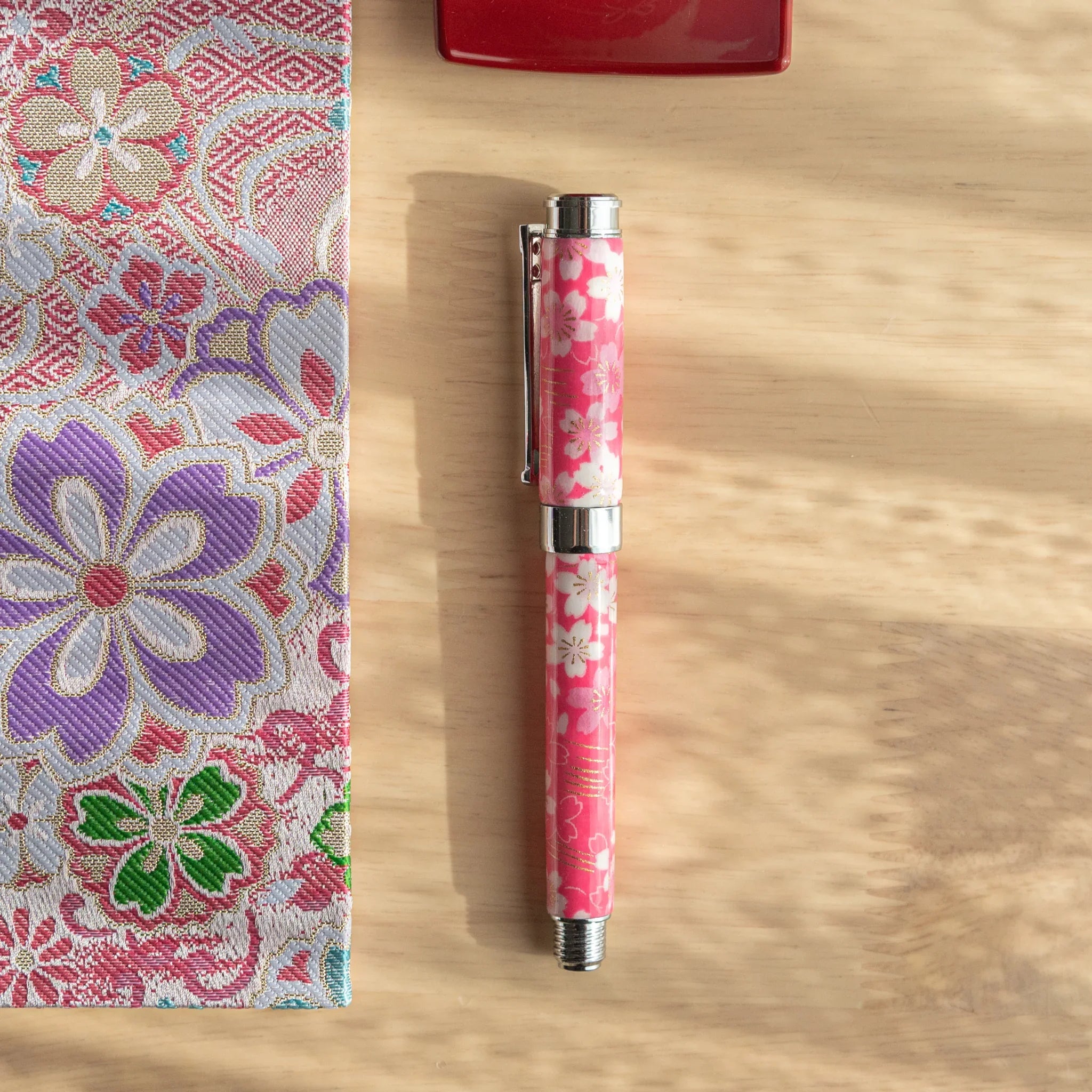 TACCIA fountain pen with pink Mino washi featuring cherry blossoms with river theme and water flow elements in detailed