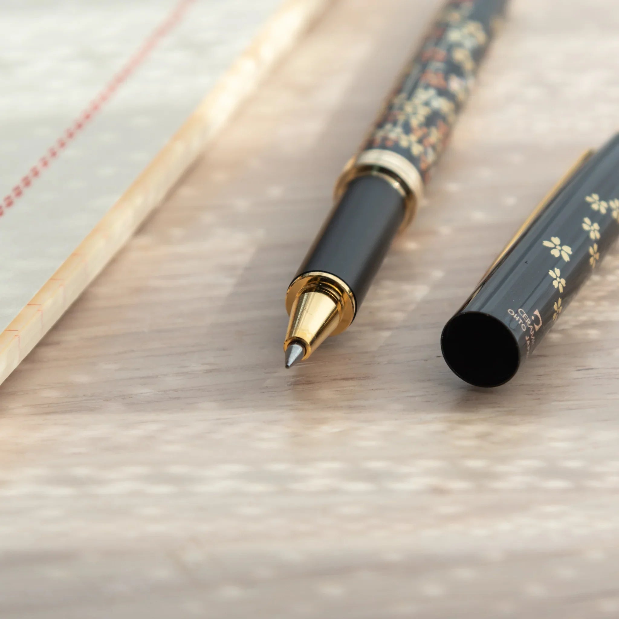 Yamanaka made ballpoint pen displays sakura artwork with subtle metallic gold leaf detail, Japan lacquer