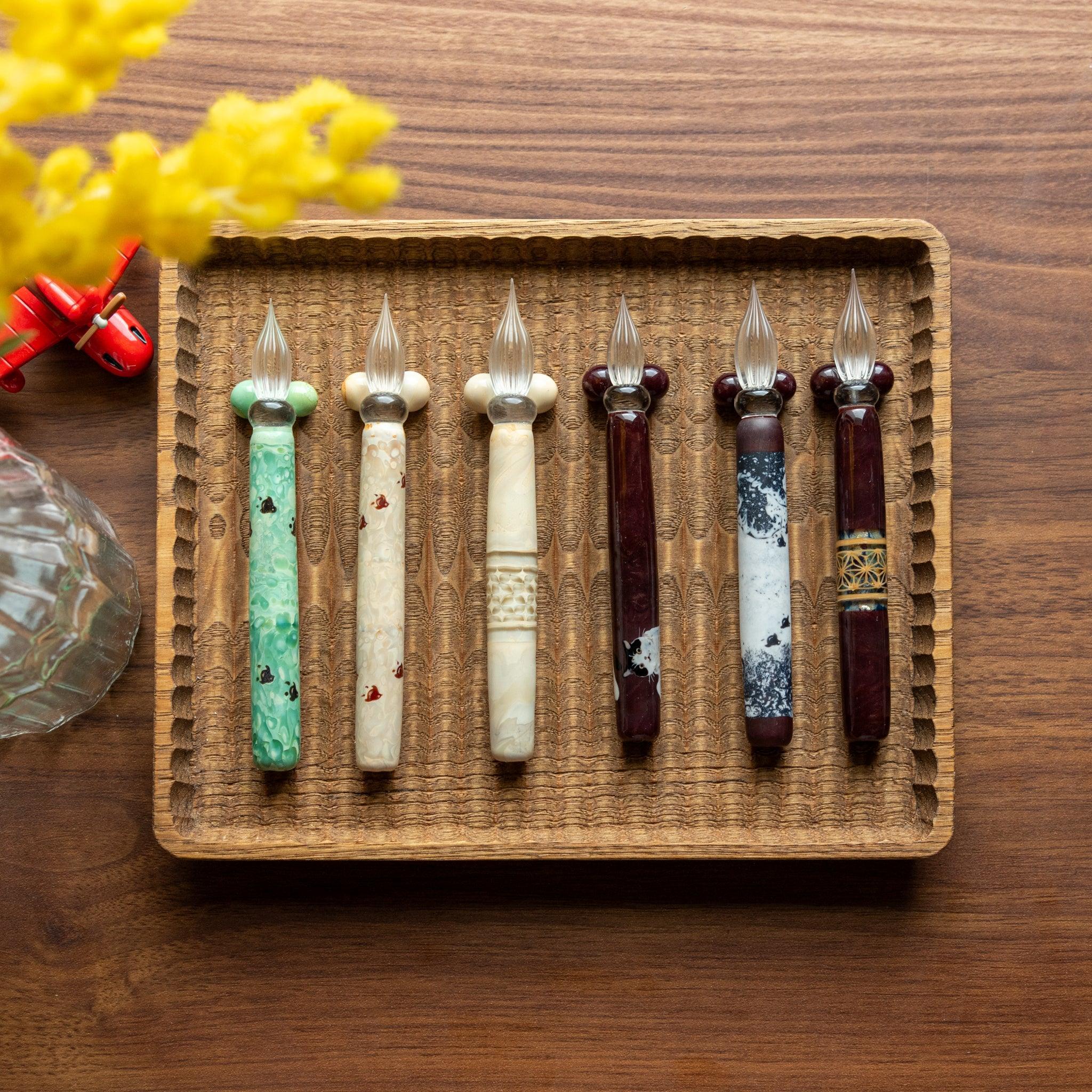 Angled view of shippo wooden dip pen showing engraved middle section and natural wood barrel construction detail