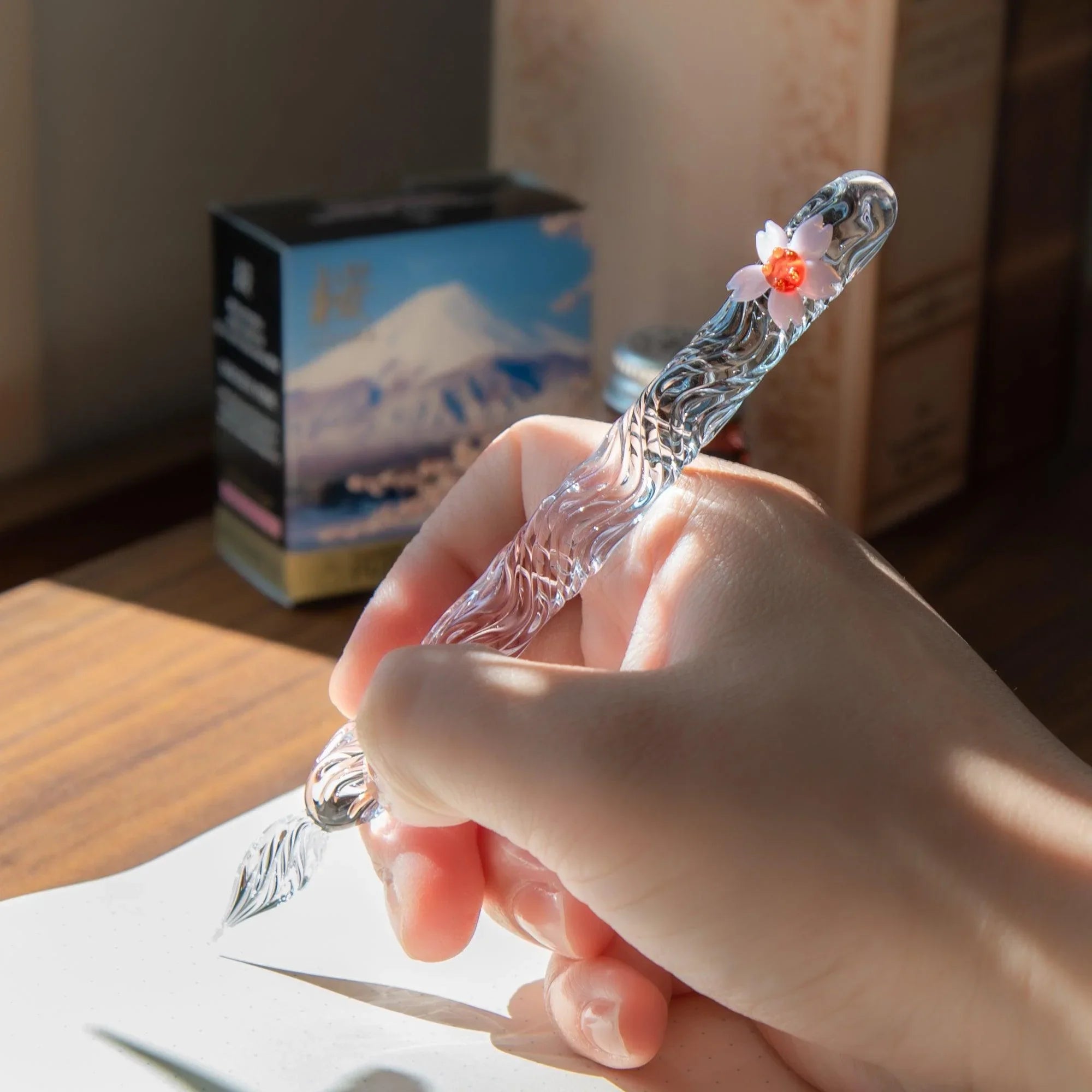 Japanese cherry blossom themed glass dip pen featuring pink sakura flower design elements and fine glass nib detail