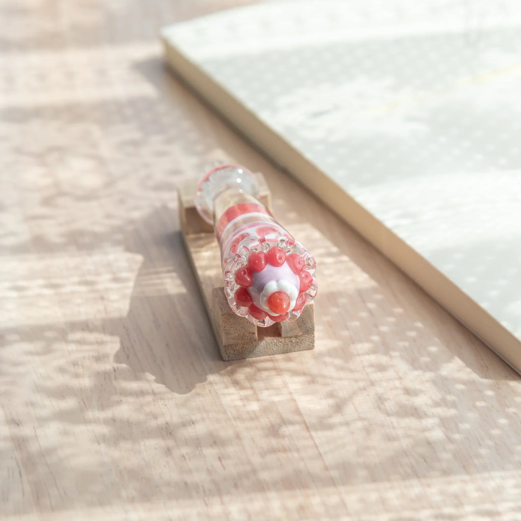 Front end view of Japanese glass dip pen parfait grip showing red berry clusters, lavender dome and cherry tip
