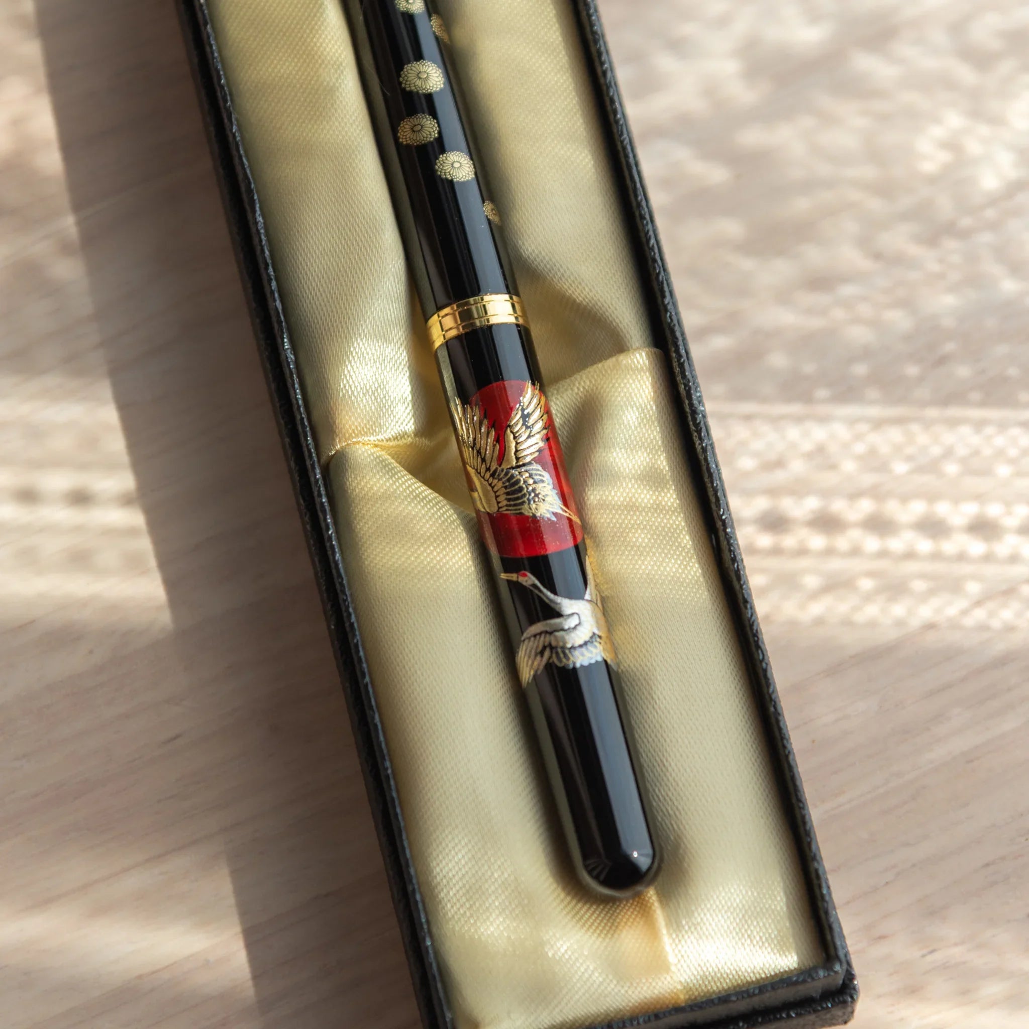 Yamanaka lacquered fountain pen displays auspicious cranes and sunrise artistic composition for writing