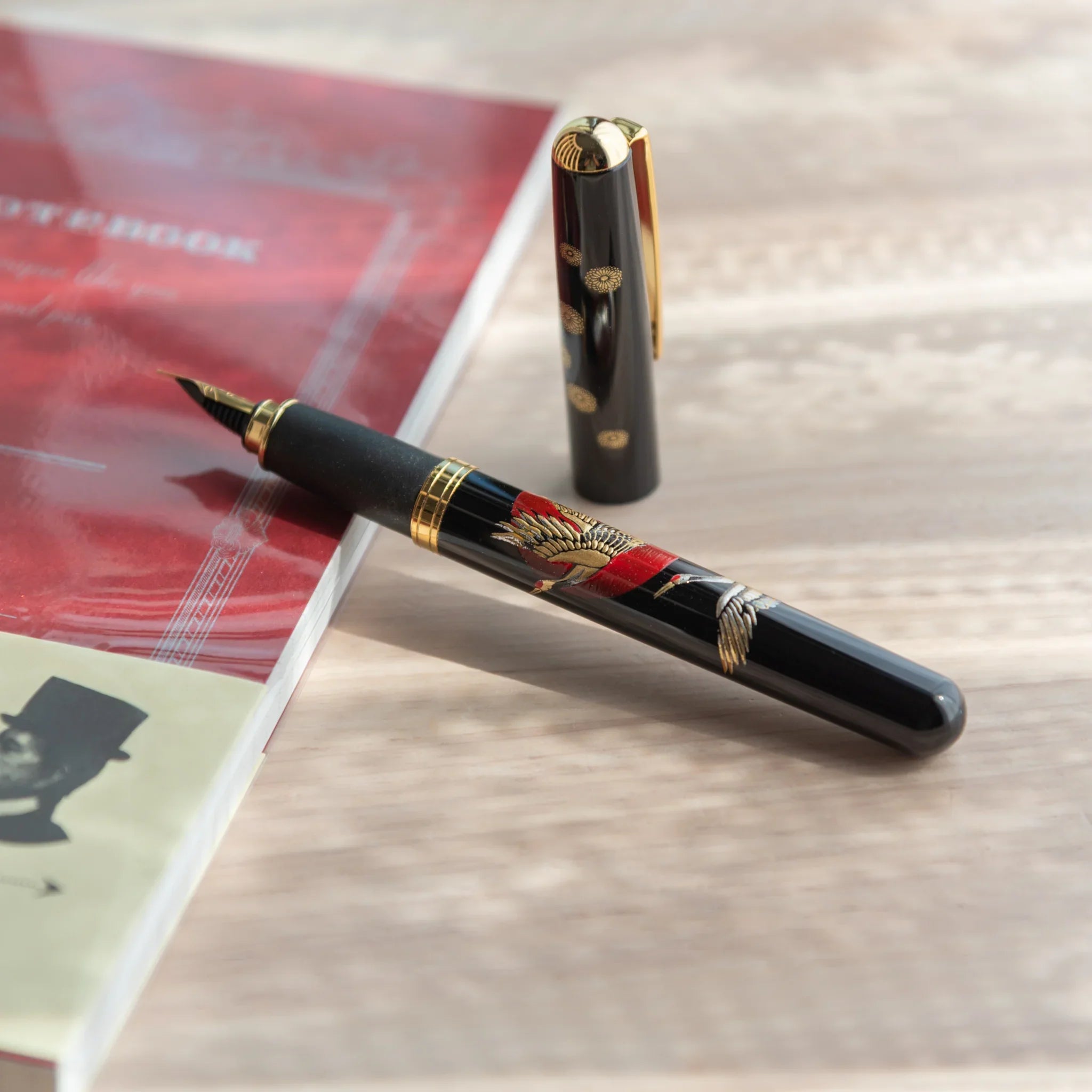 Japanese Yamanaka lacquer fountain pen features auspicious cranes and sunrise landscape design for writing