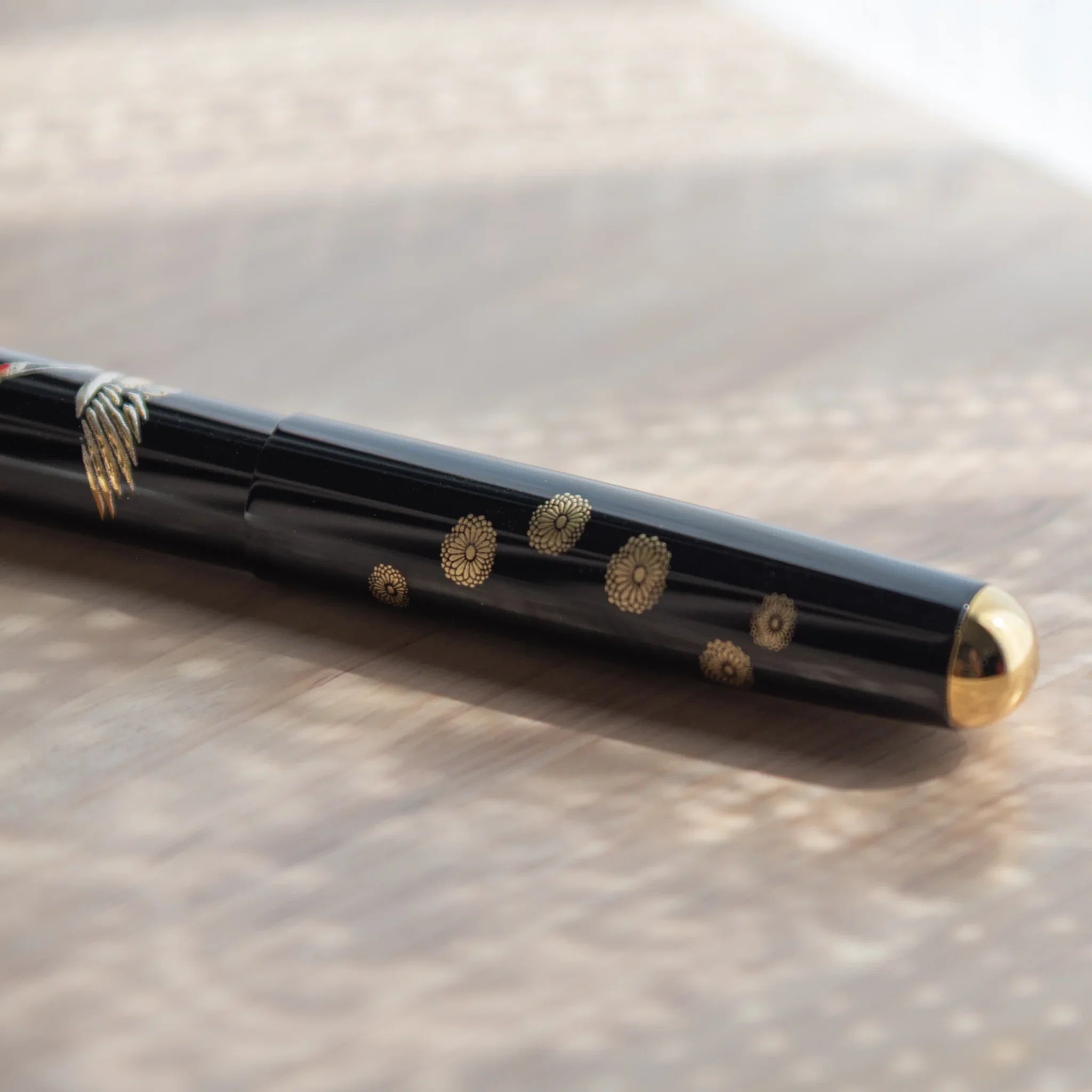 Traditional Yamanaka lacquered fountain pen depicts auspicious cranes and morning light scene for writing