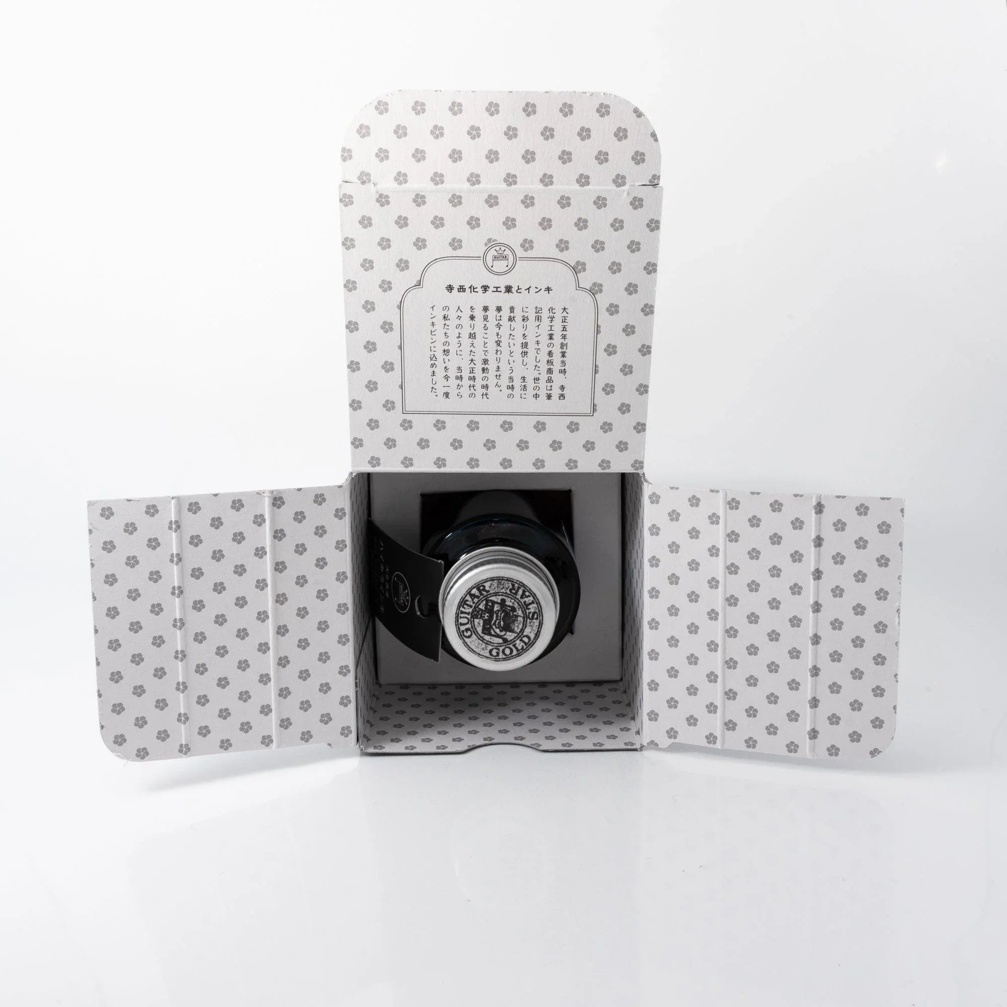 Lady Emerald Taisho Romance Japanese fountain pen ink bottle with metal cap beside product packaging box