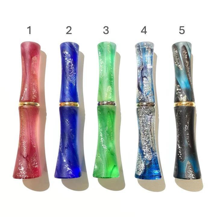Decorative glass dip pen, closed view showing hand-made swirled design and artistic glass detail with artistry