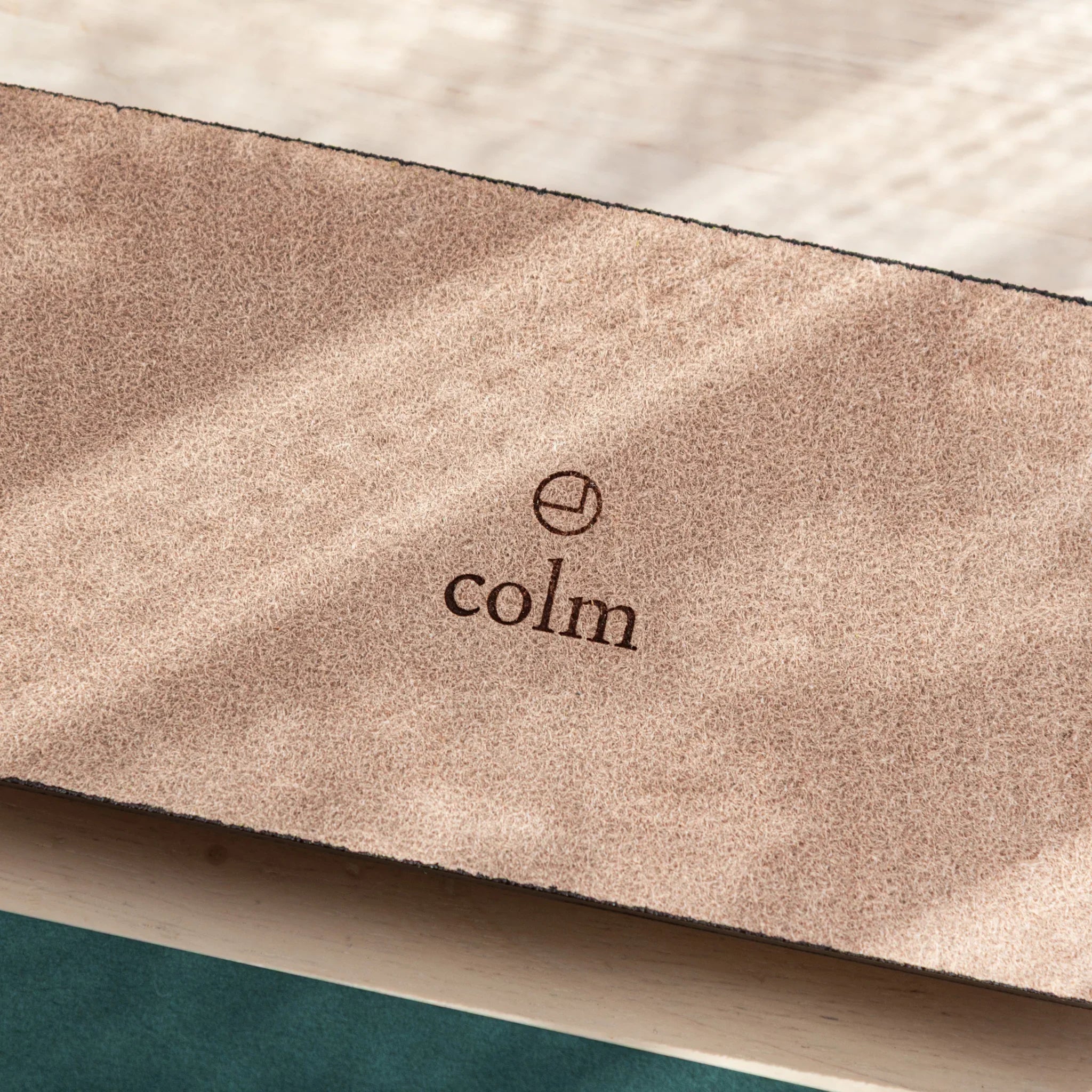 Burgundy suede pen tray close-up with colm brand imprint on backing showing tray construction details