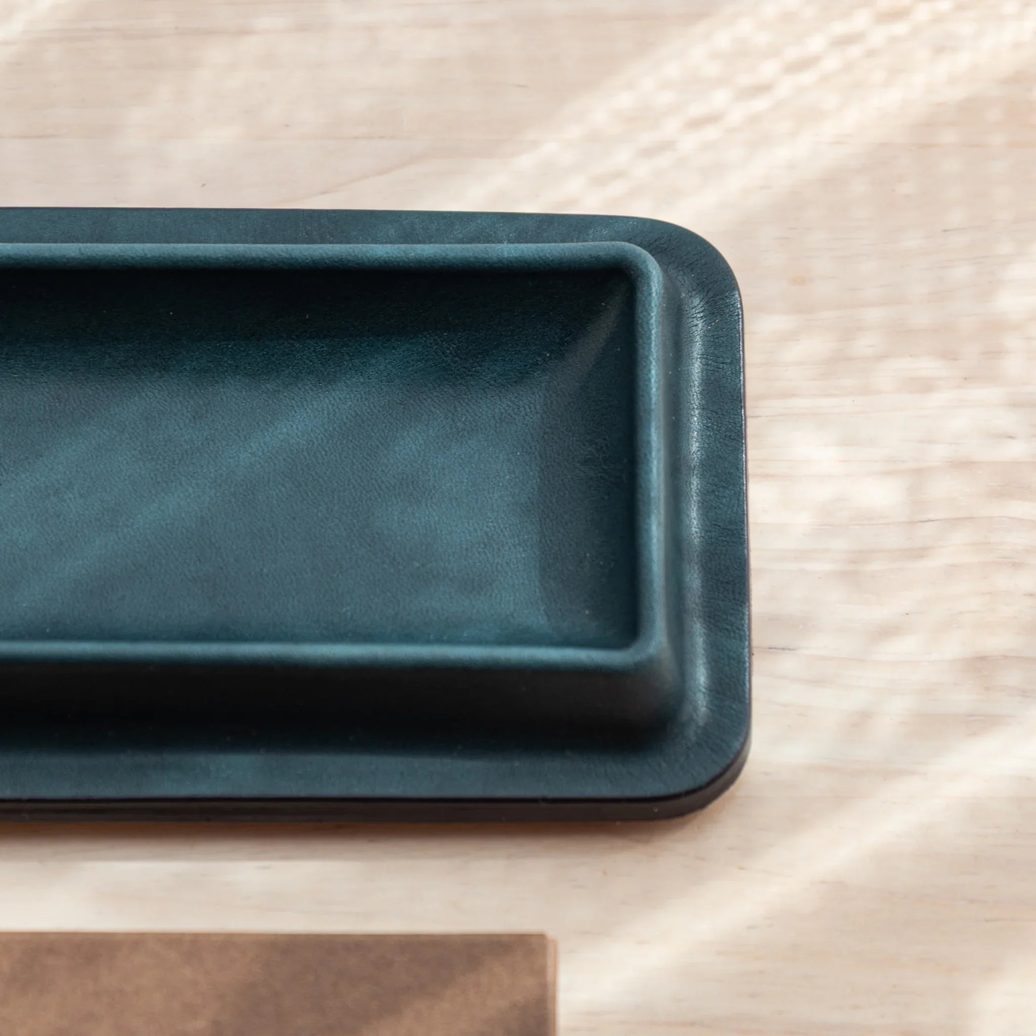 Olive green suede corner detail showing snap buttons and material finish of the tray surface clearly