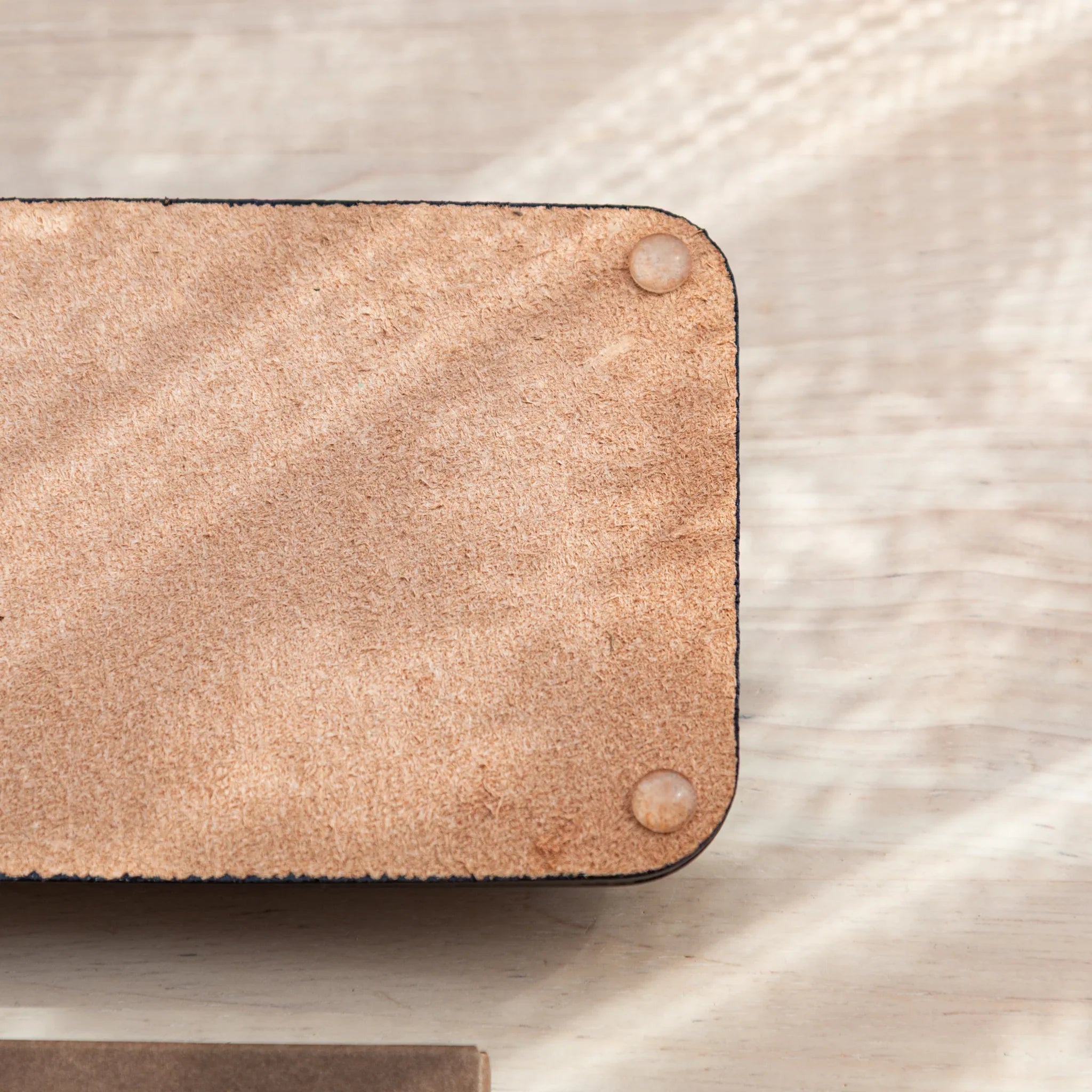 Olive green suede corner with snap button closure showing tray hardware and fastening detail clearly