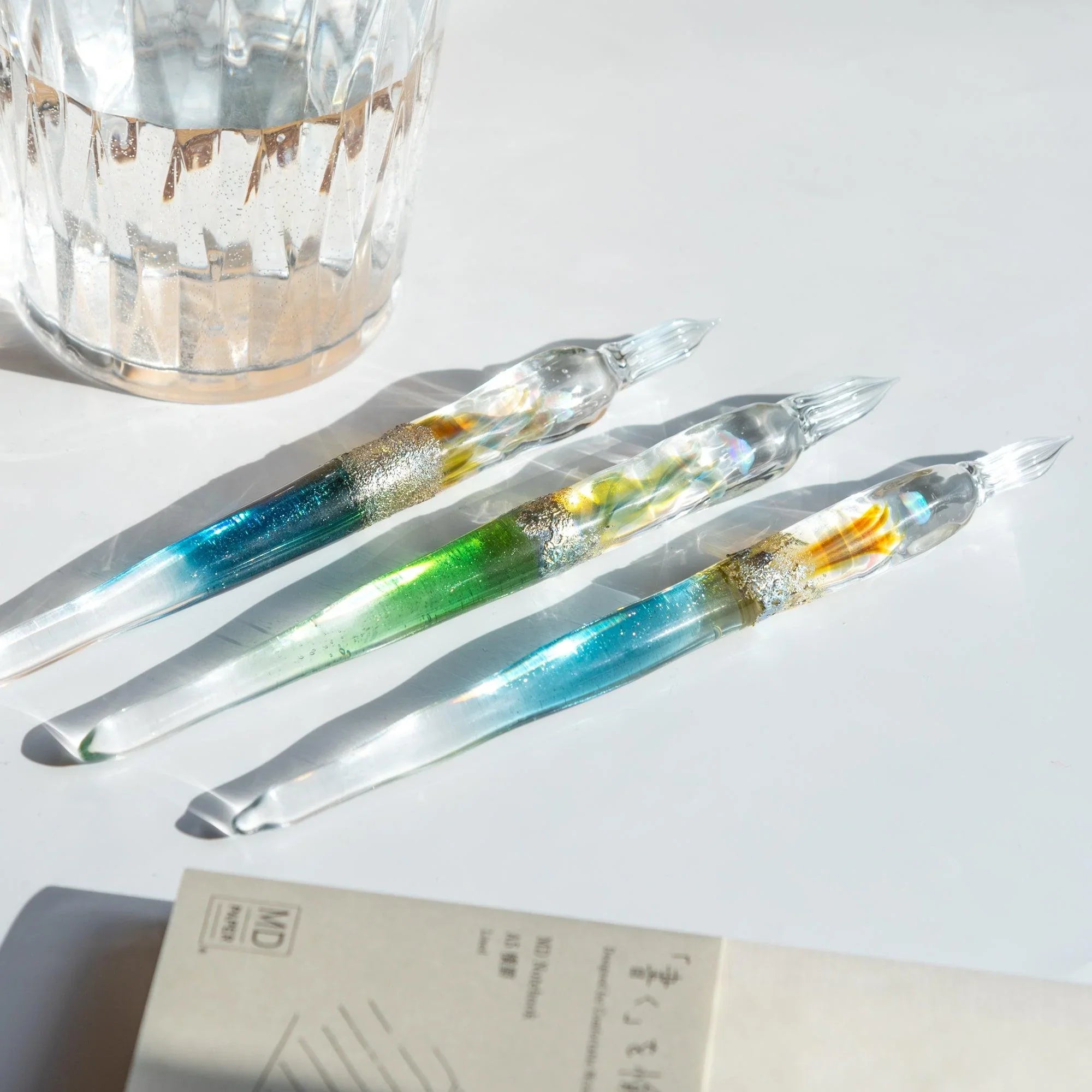 Tsukuyomi green glass dip pen shot from side angle highlighting translucent green material and metallic accents