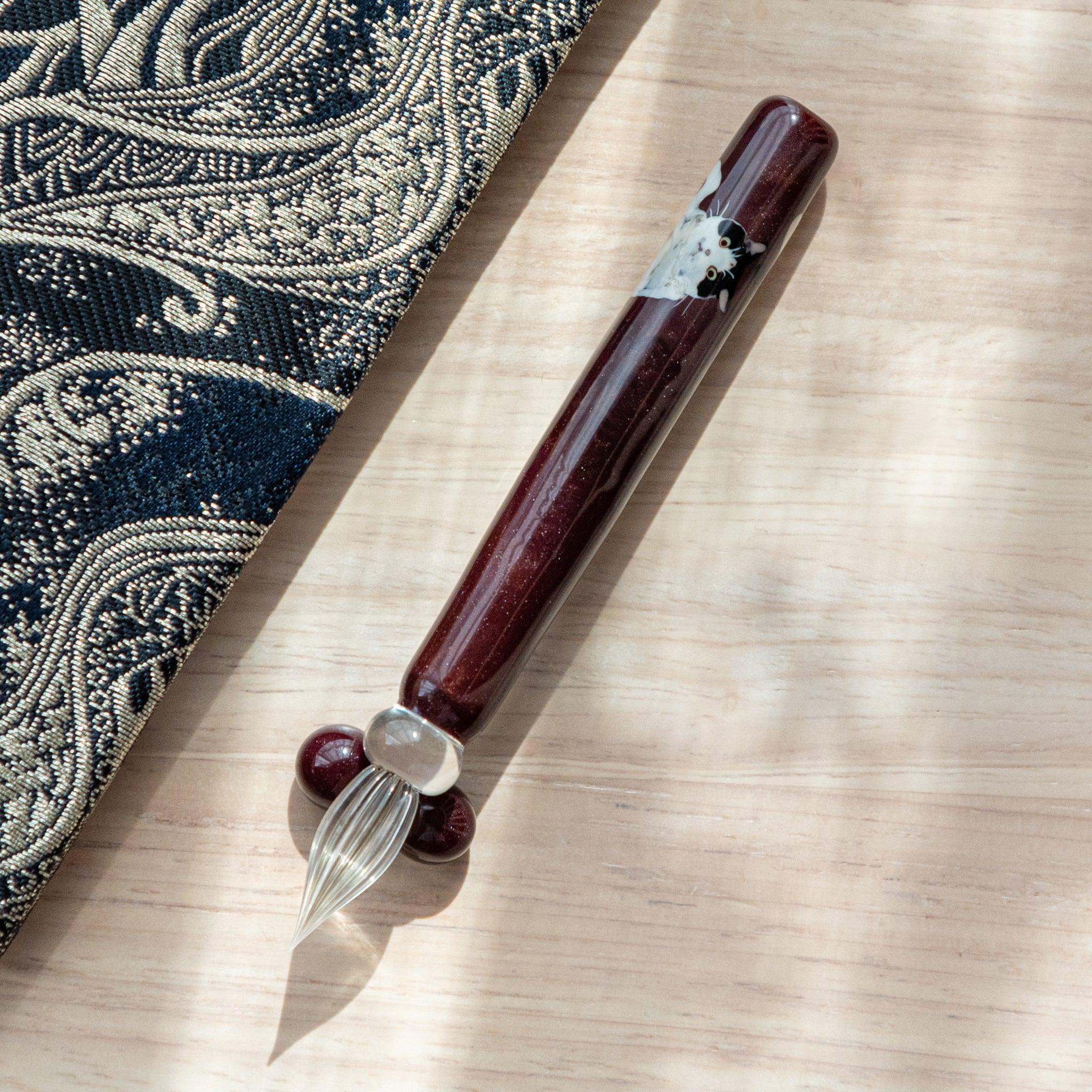 Tuxedo Cat Glass Dip Pen with Pen Rest side angle showing black and white feline pattern around transparent glass barrel