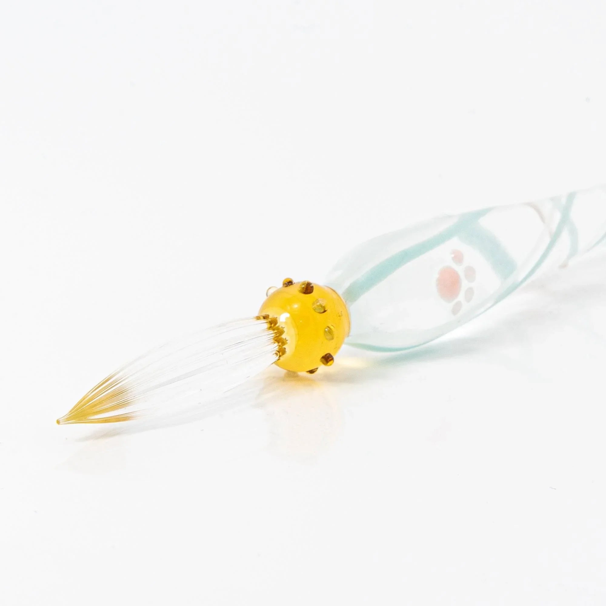White Nyanko sitting cat on clear transparent spiral-etched glass dip pen in angled detail photograph