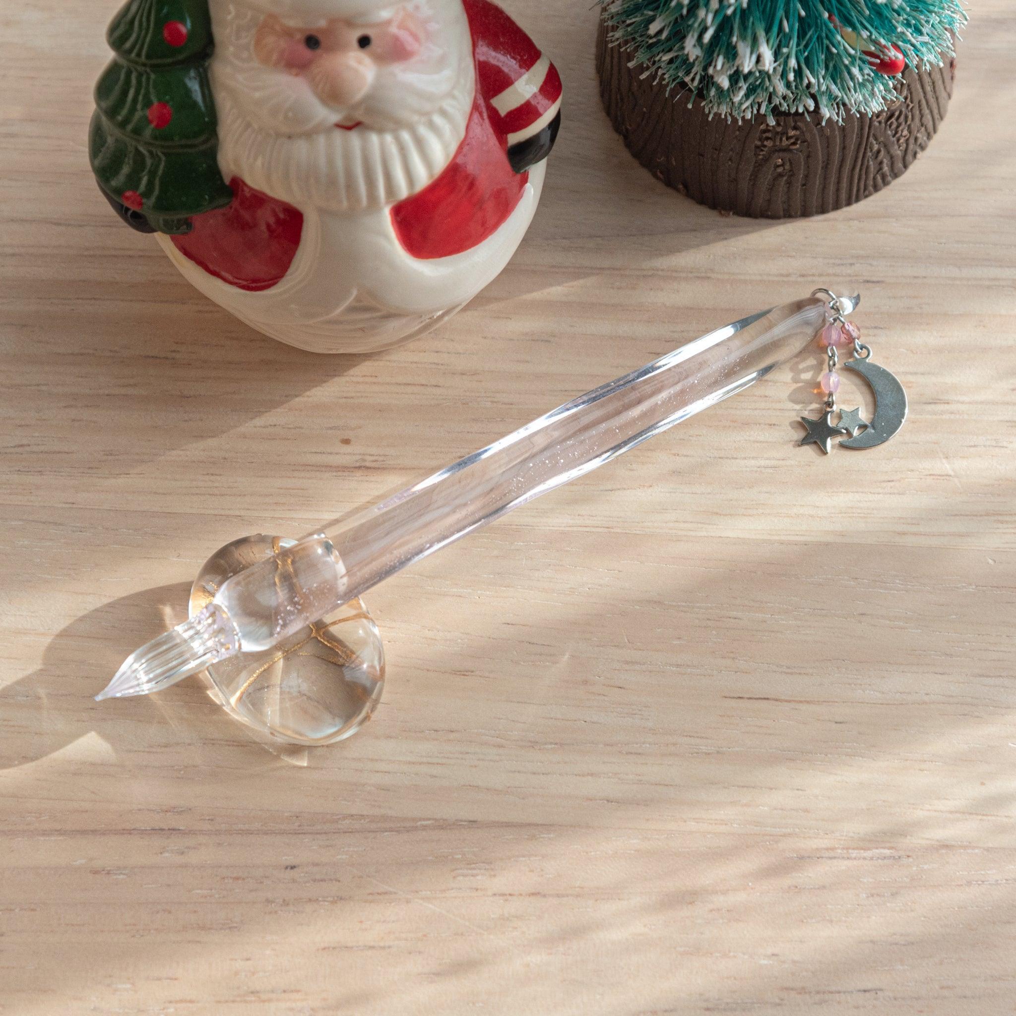 Pink glass dip pen with wish upon a star design showing celestial and stellar motif pattern throughout piece top