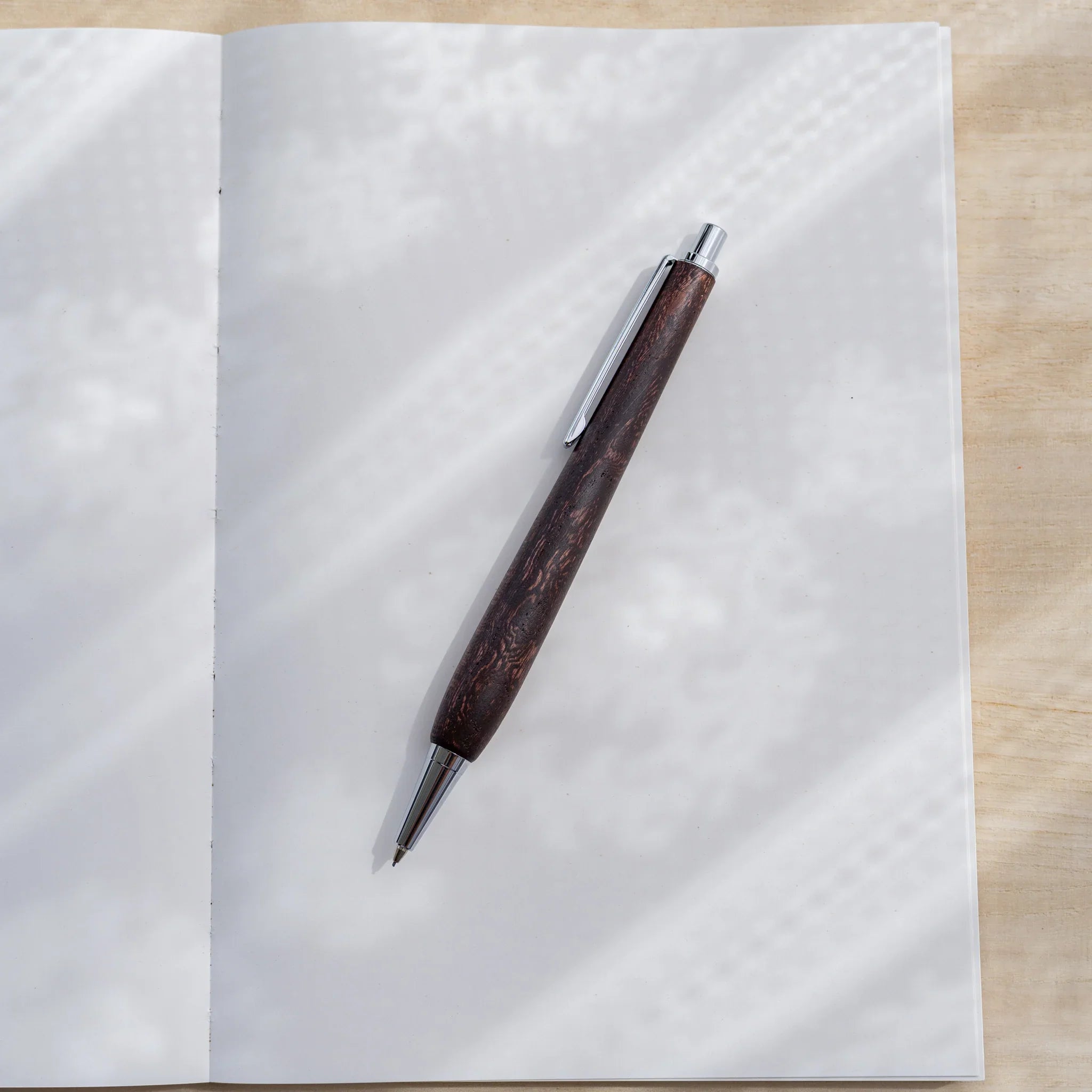 Dark reddish-brown zelkova wood urushi mechanical pencil, close-up of barrel wood grain and clip, Japanese keyaki