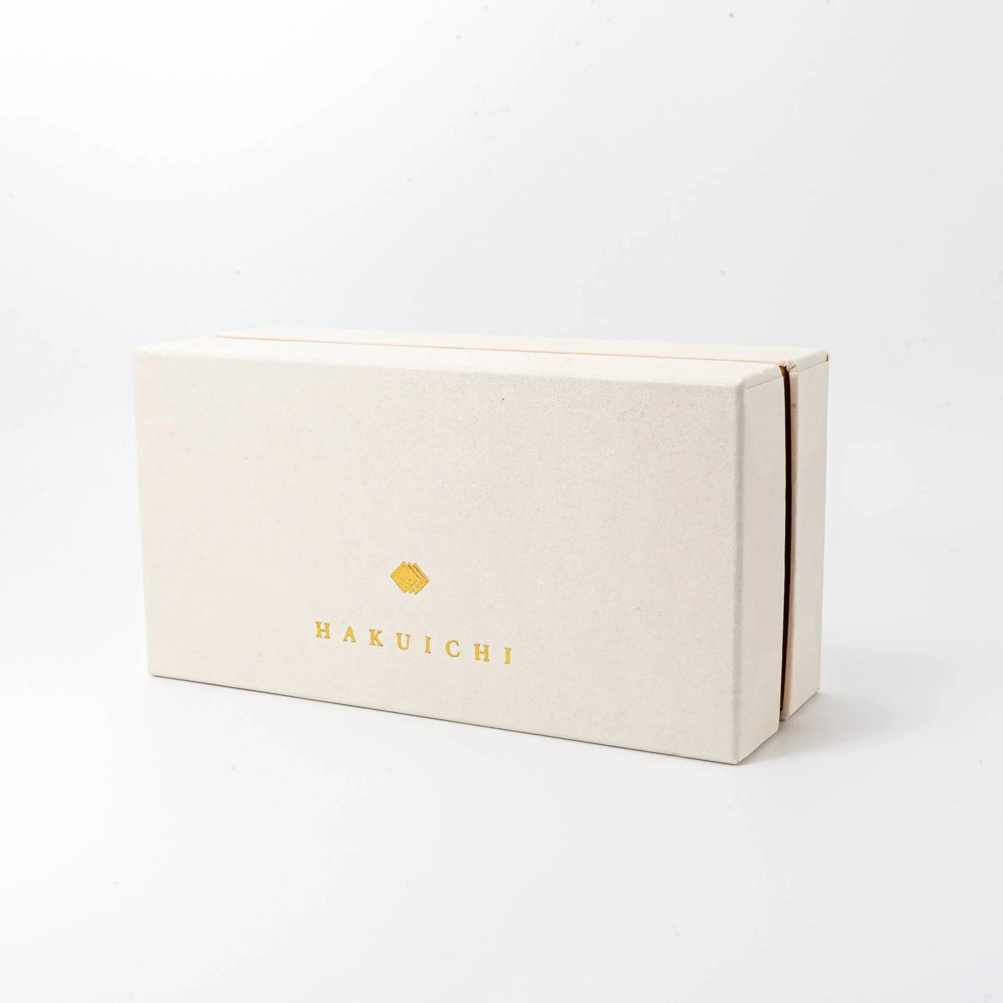 Pair of Japanese gold ceramic auspicious crane pen rests in beige branded packaging with Hakuichi logo visible