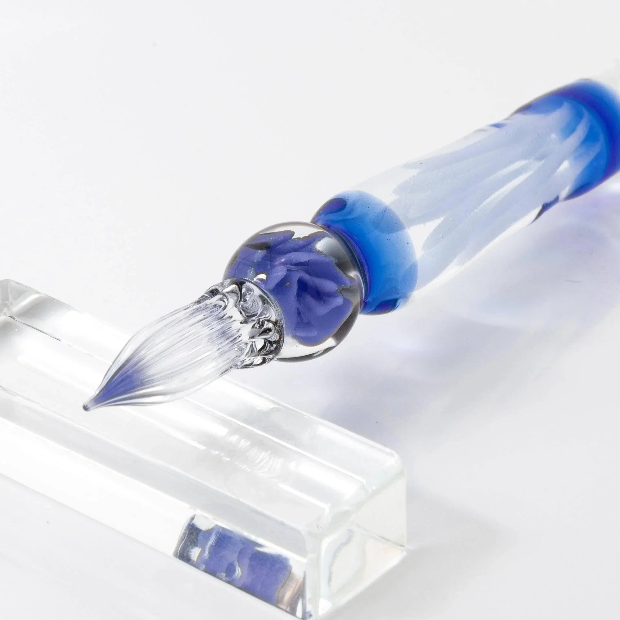 Blue Rose Glass Dip Pen with blue rose petals visible inside glass barrel, angled pen displayed with ornate metal band