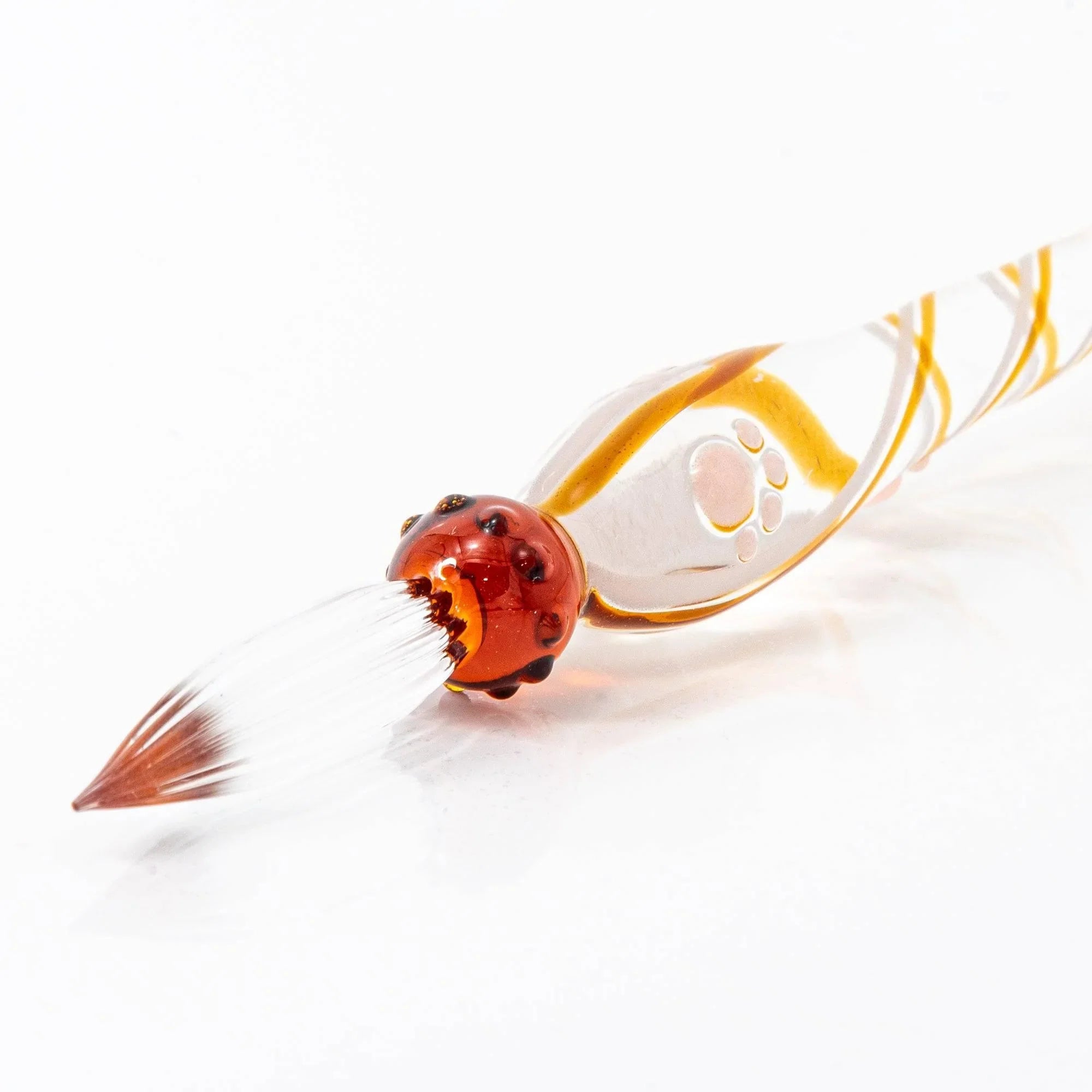 Brown Tabby Nyanko cat glass dip pen close-up showing red cat face and yellow striped glass barrel design