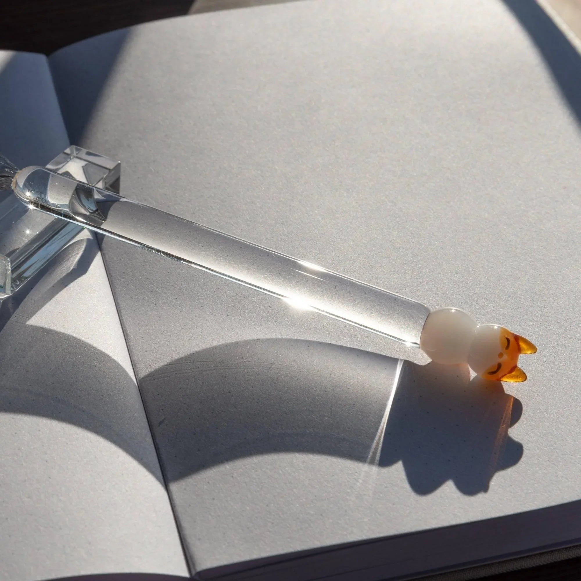 Detailed close-up of Cat Perch glass dip pen nib showing fine point and artisanal twisted construction with holder