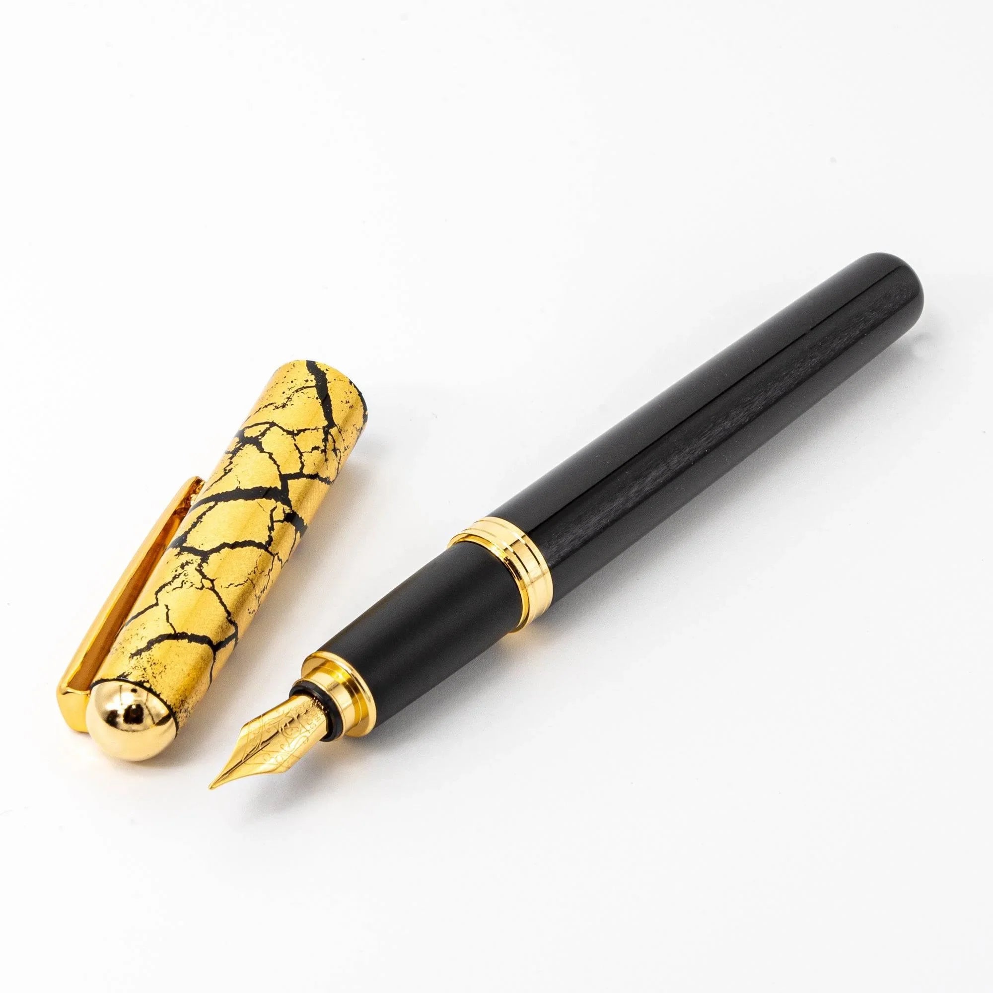 Black capped fountain pen with gold crackle pattern, fine Japanese lacquer craft, dark glossy barrel detail